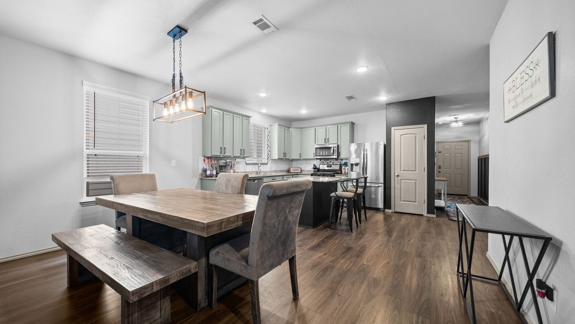 4170 Hidden Timbers Lane, Conroe, TX 77304 Gather around the table! This spacious dining area features a beautiful modern light fixture and an open layout perfect for everyday meals or entertaining.