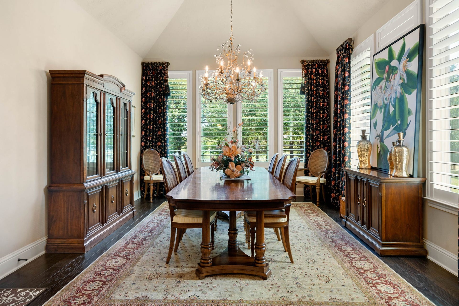 34 Edgemont Court, Fulshear, TX 77441 The formal dining area features a vaulted ceiling, shutters, and a statement chandelier for elegant entertaining.