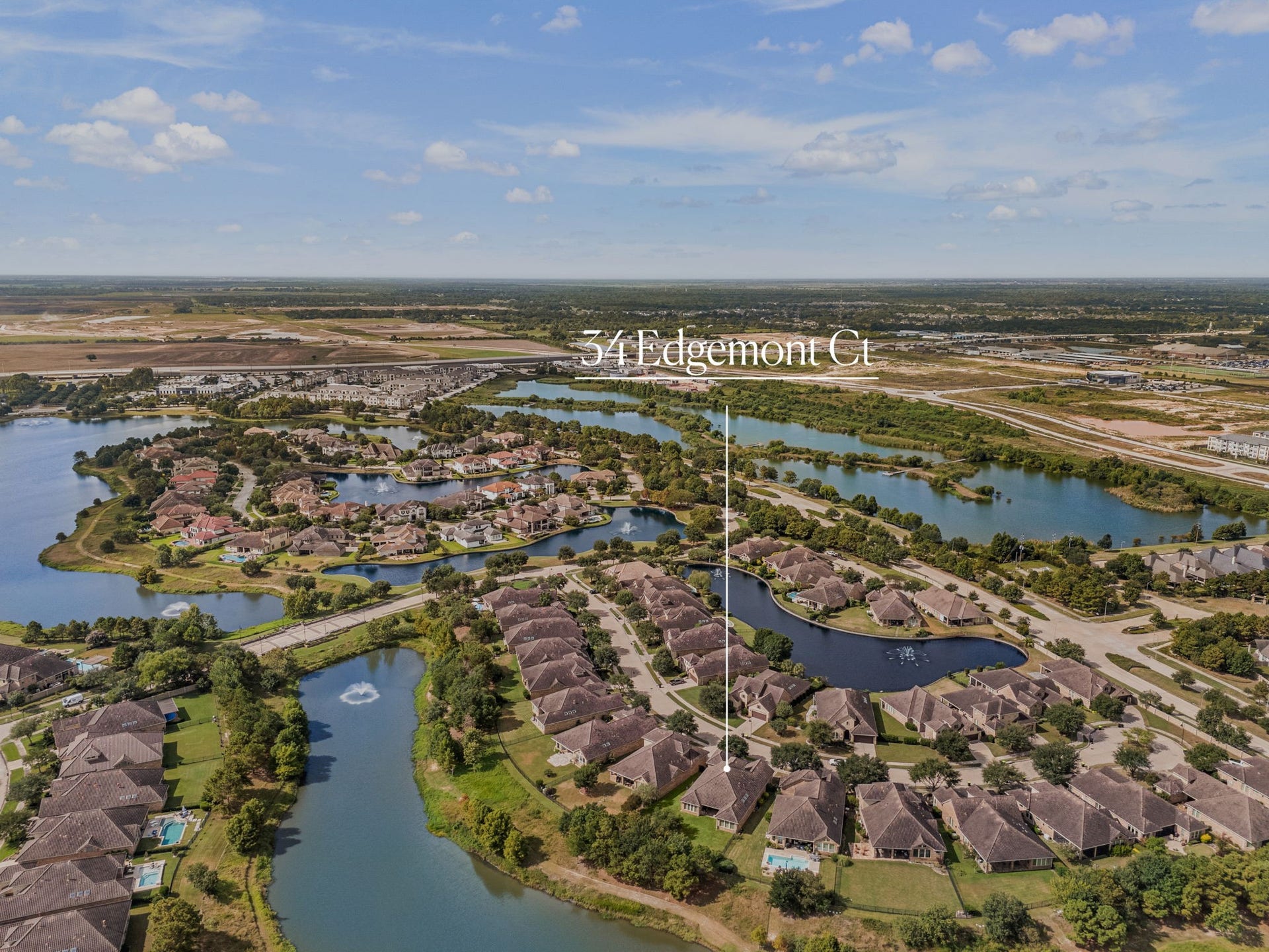 34 Edgemont Court, Fulshear, TX 77441 Positioned along the water, this view captures 34 Edgemont Ct's proximity to the community's lake and scenic walking paths.