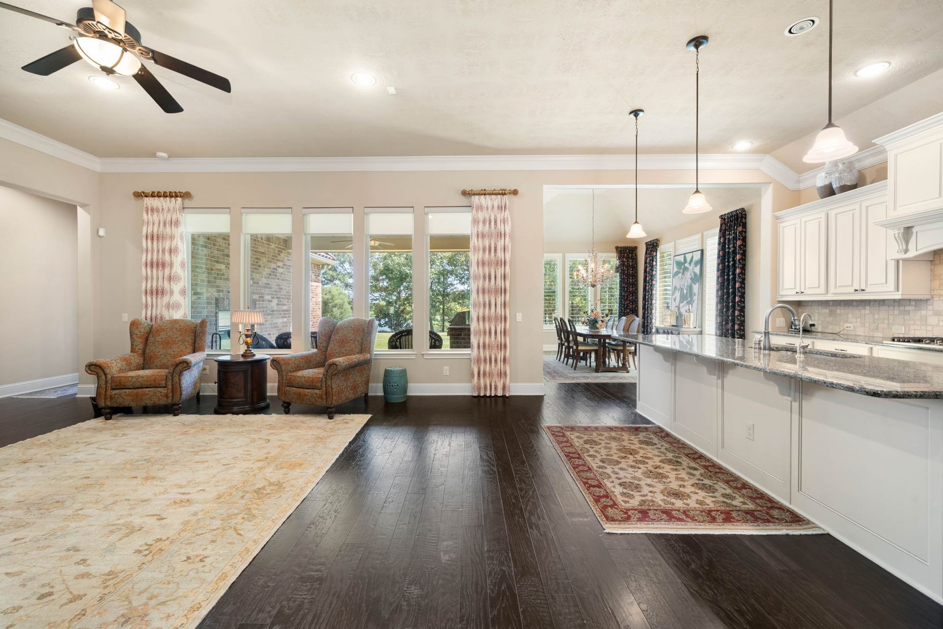 34 Edgemont Court, Fulshear, TX 77441 Wired for sound and finished with dark hardwood floors throughout, the open living area flows effortlessly into the kitchen and dining space.