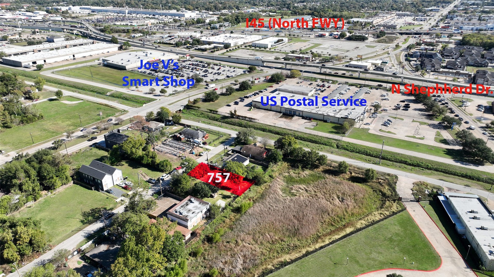 This aerial photo shows a property marked in red, labeled "757," situated in a residential area. It is conveniently located near major roads, with nearby amenities including Joe V's Smart Shop and a US Postal Service office. The surrounding area features both residential and commercial properties, providing a blend of community and convenience.