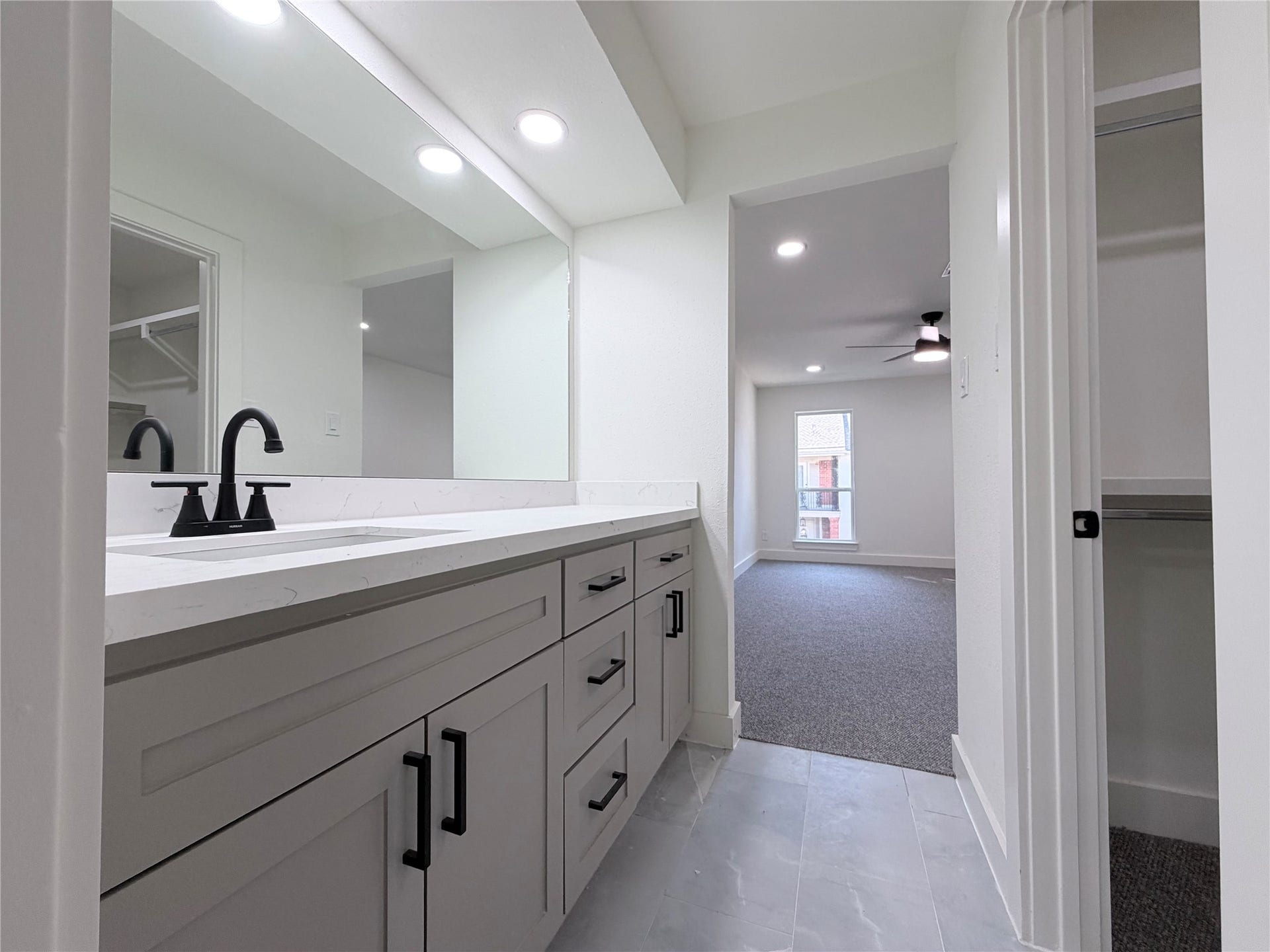 14309 Misty Meadows Lane, Houston, TX 77079 Primary bedroom offer double sinks with seperate vanities and walk in closet on the left.