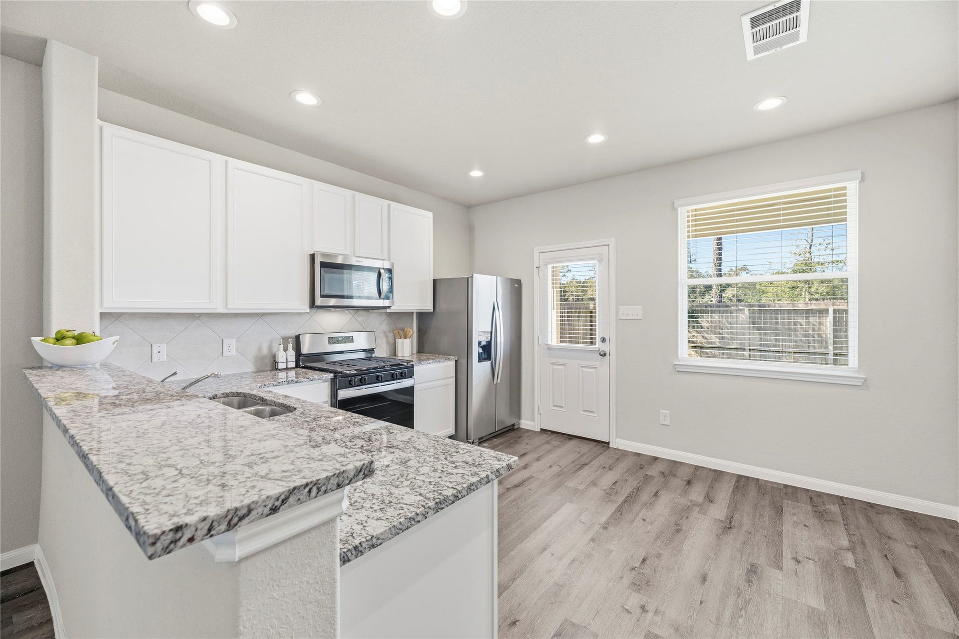 2276 Raider Drive, Conroe, TX 77301 Kitchen and dining area with backyard access