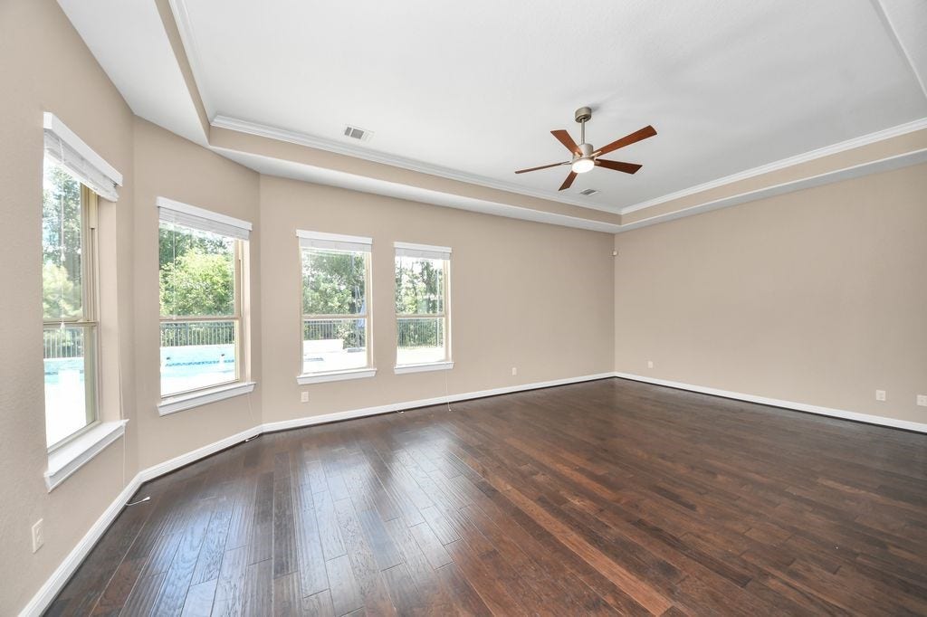 4035 Ashland Woods Drive, Spring, TX 77386 There is a large sitting area in the primary suite, with a tray ceiling and gorgeous views of the pool.