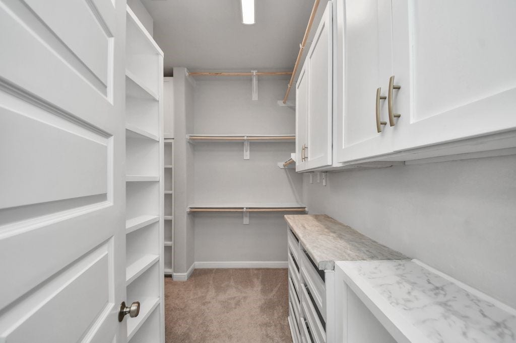 4035 Ashland Woods Drive, Spring, TX 77386 One of the TWO closets in the primary suite, custom shelving, cabinetry & drawers in this one!