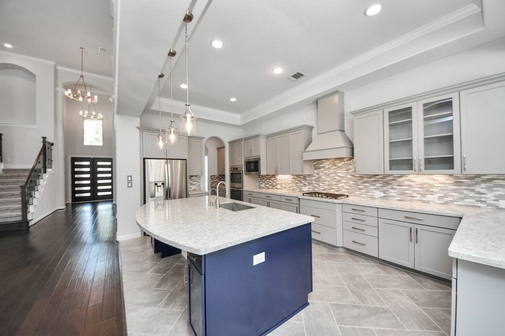 4035 Ashland Woods Drive, Spring, TX 77386 Glass front cabinets, pendant lighting, under cabinet lighting and double ovens are just some of the custom features this home has to offer. The refrigerator is also included.