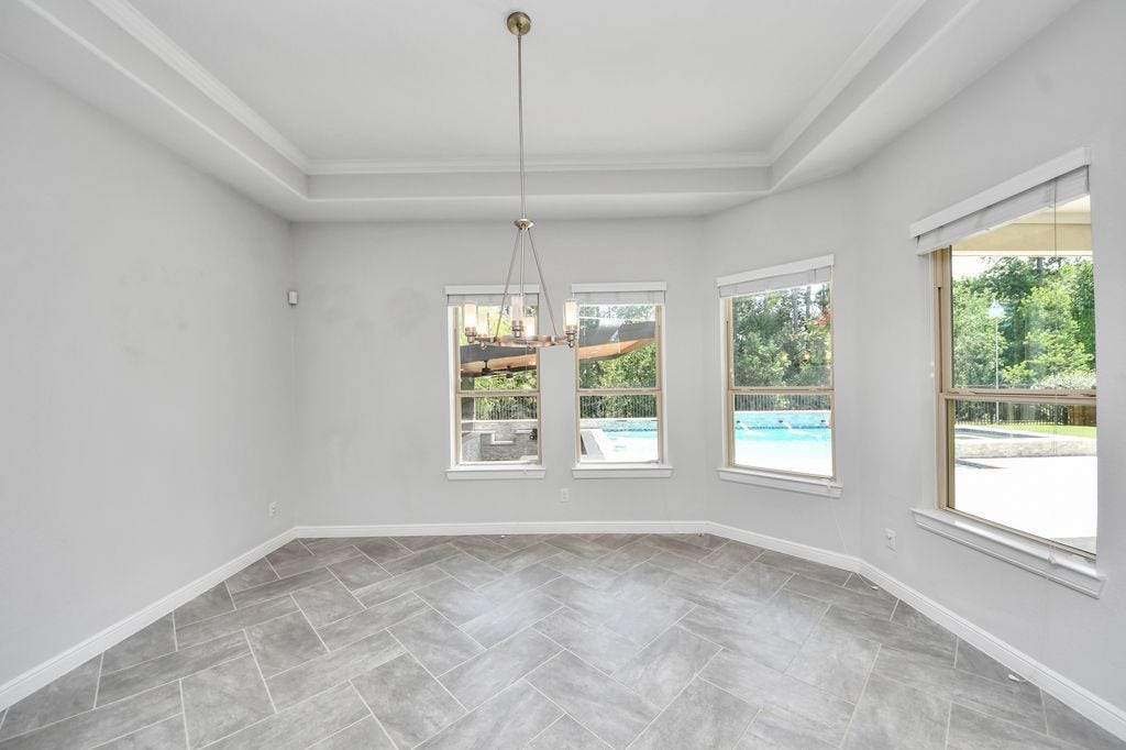 4035 Ashland Woods Drive, Spring, TX 77386 Breakfast room with views of the pool, covered culinary center & greenbelt.