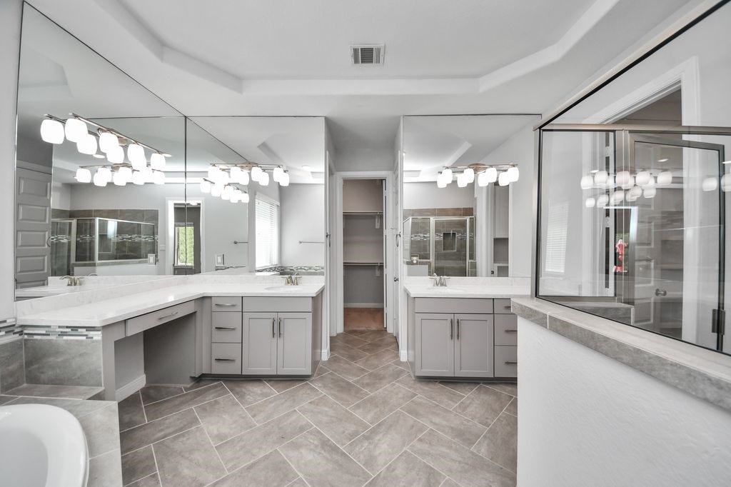 4035 Ashland Woods Drive, Spring, TX 77386 The primary bath has a large walk-in shower, double vanities & sinks.