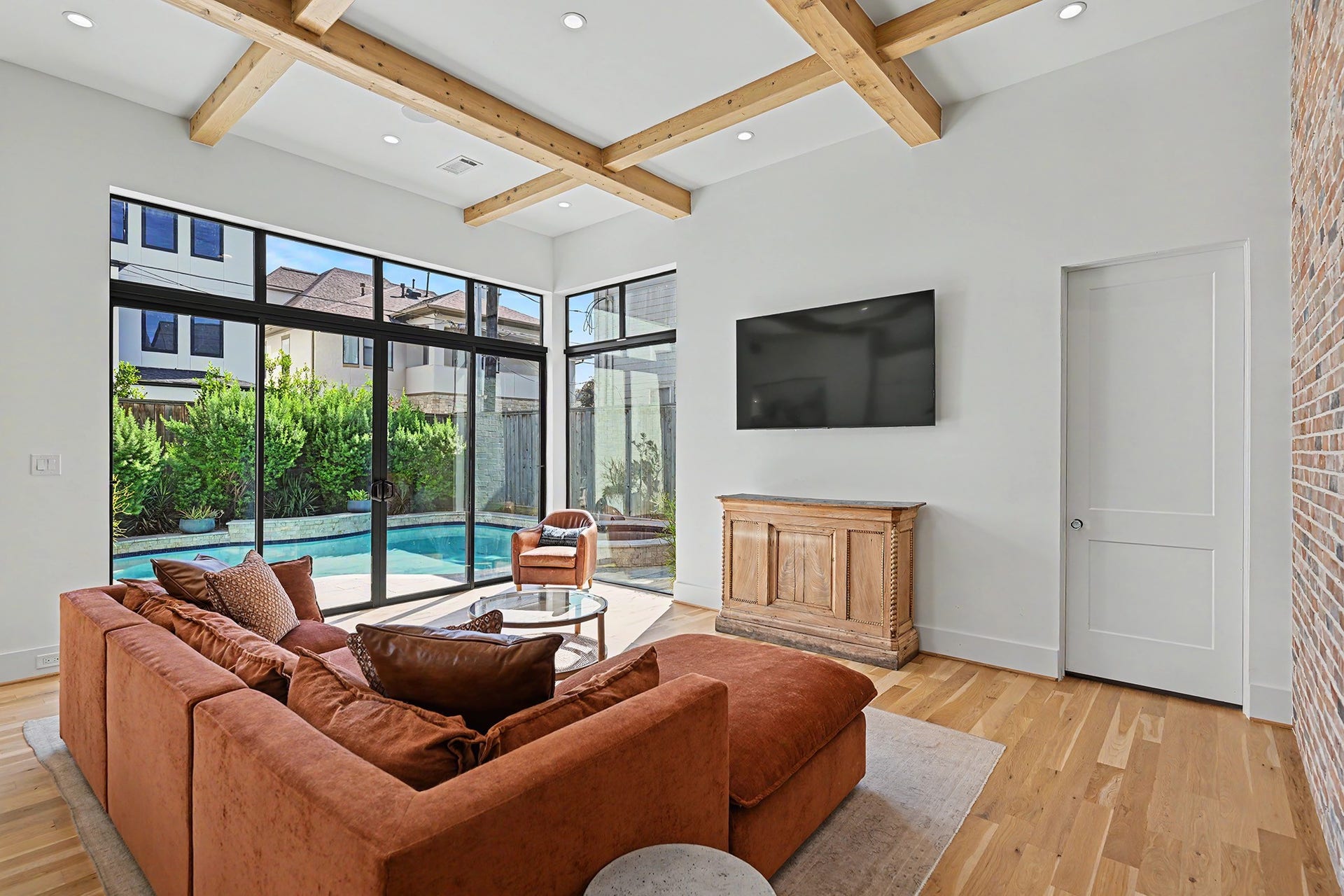 1605 Mcduffie Street, Houston, TX 77019 Walls of glass connect the living room to the pool, creating a seamless indoor-outdoor experience.