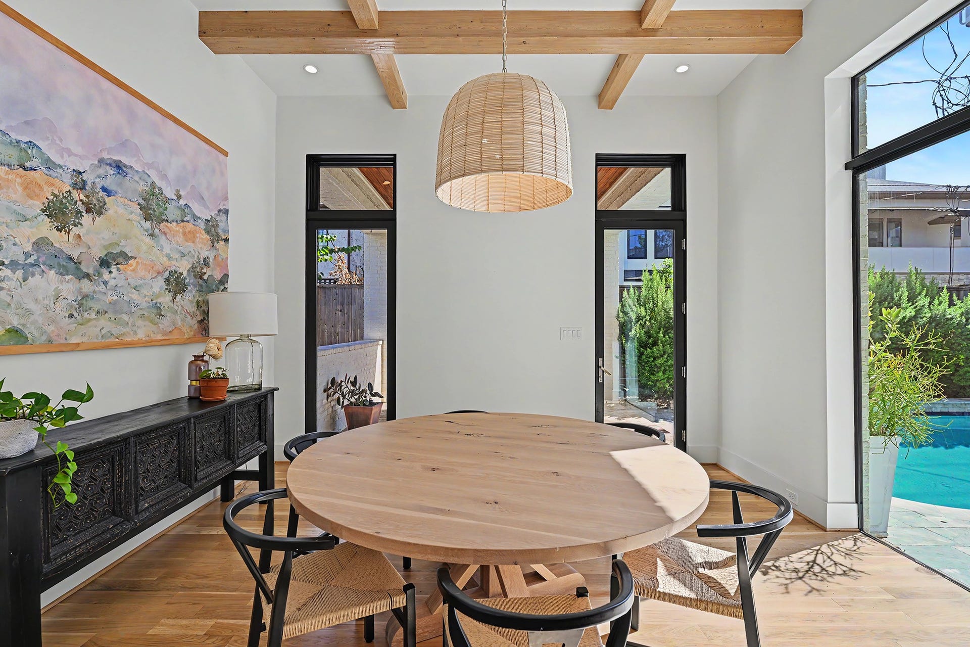 1605 Mcduffie Street, Houston, TX 77019 The dining room is illuminated by a woven fixture and opens directly to the pool.