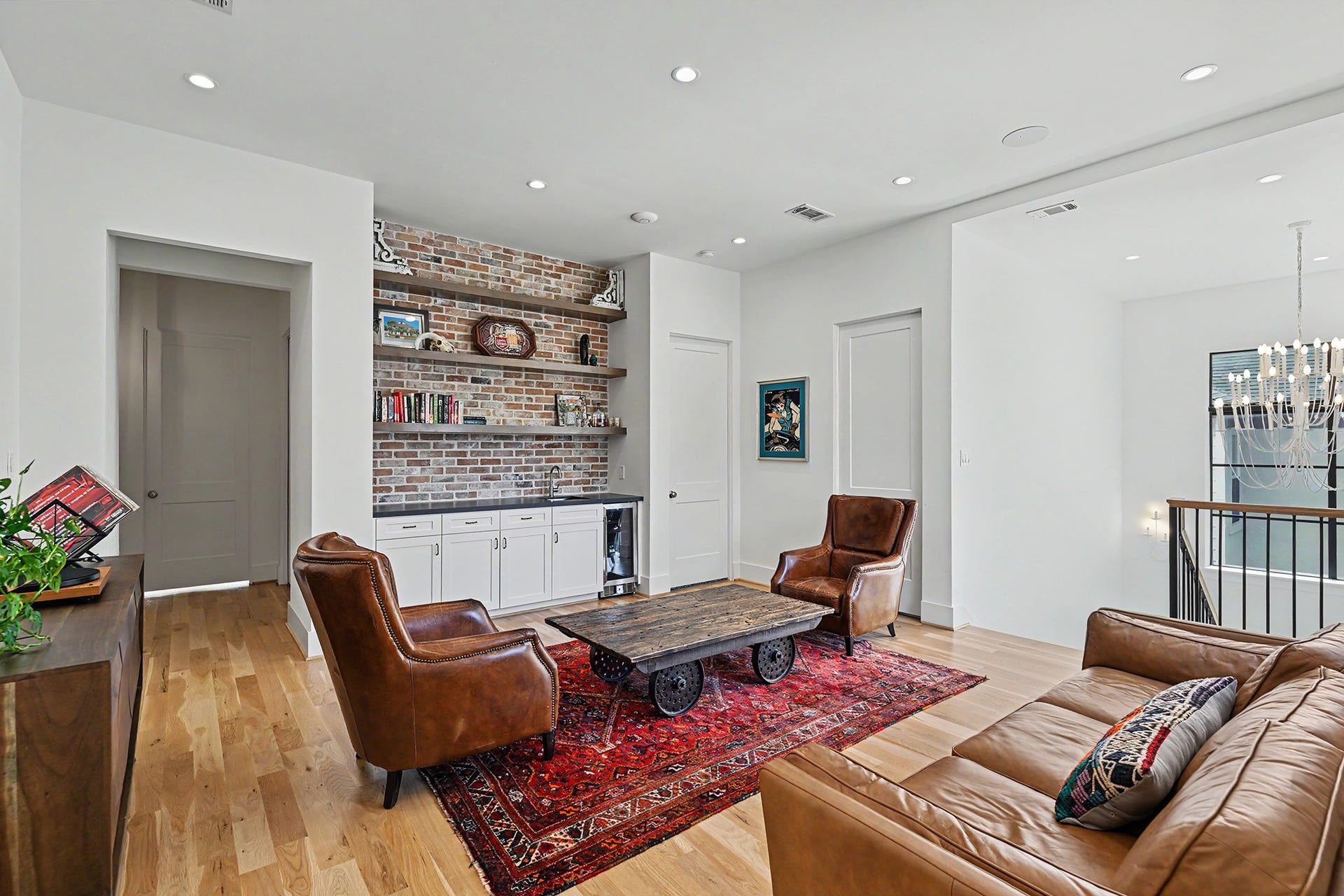 1605 Mcduffie Street, Houston, TX 77019 A second view of the game room highlights custom built-ins, antique like hardware and a handsome brick accent.