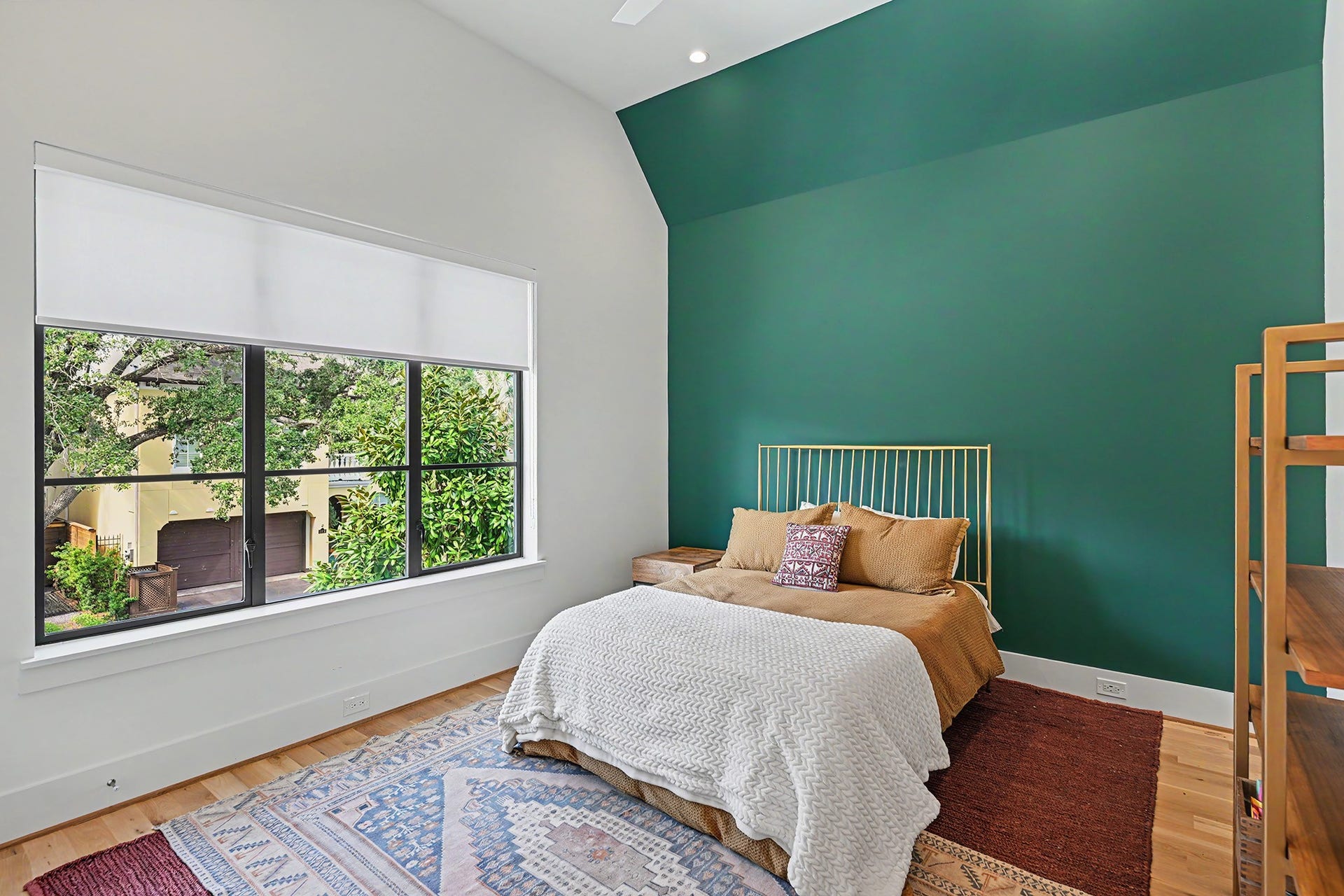 1605 Mcduffie Street, Houston, TX 77019 A striking accent wall and oversized window bring color and character to this secondary bedroom.