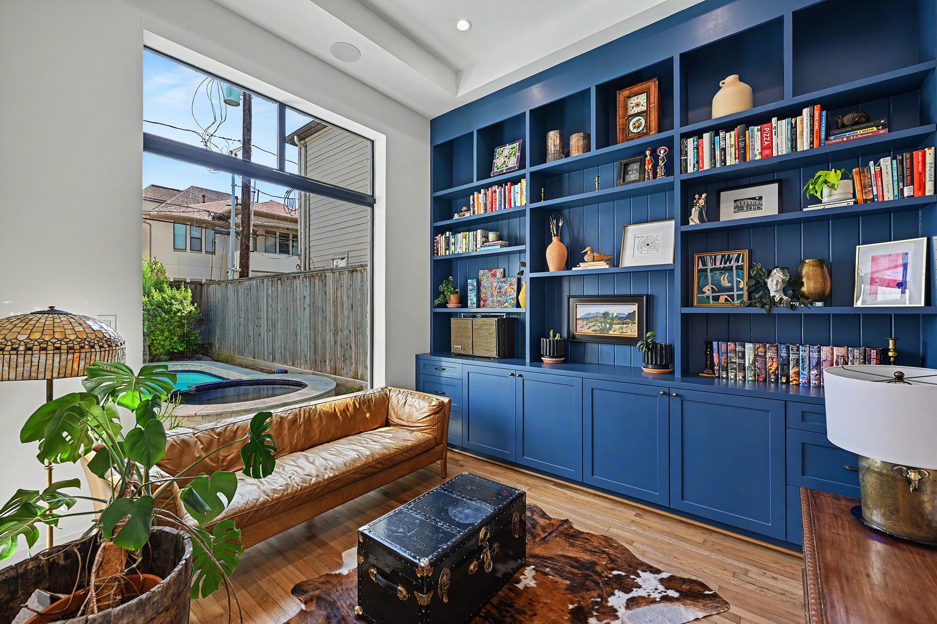 1605 Mcduffie Street, Houston, TX 77019 The study pairs preserved hardwood from the original 1920 home with custom blue built-ins and antique hardware.