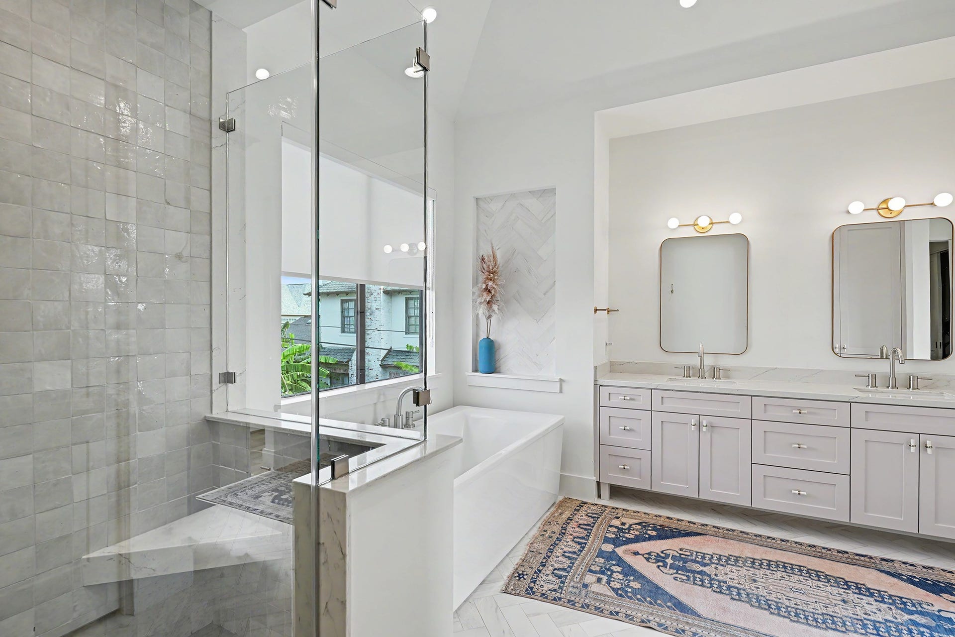 1605 Mcduffie Street, Houston, TX 77019 The glass-enclosed primary shower showcases beautifully selected Riad tile and a spacious, tailored design.