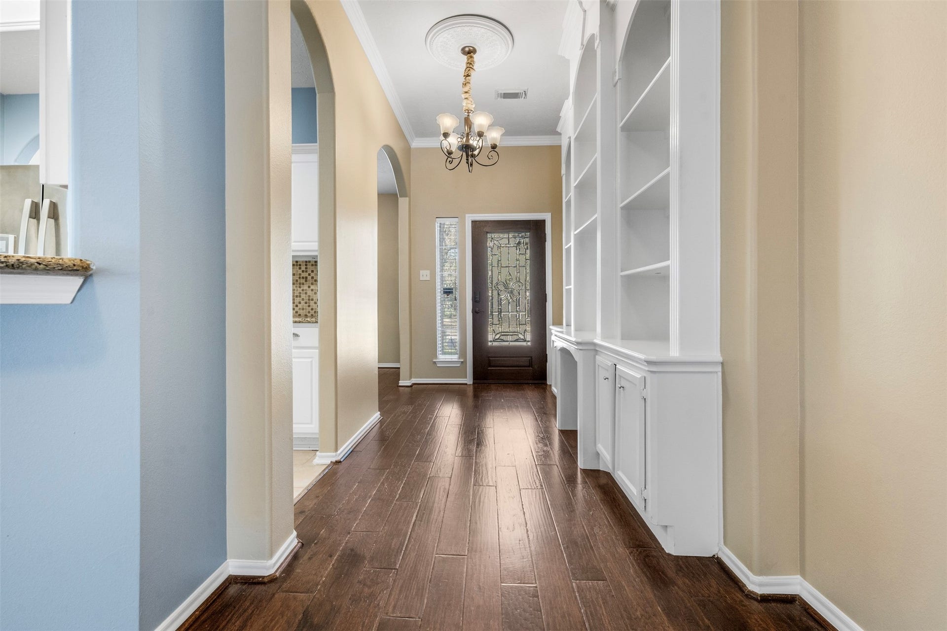 12902 Cascadia Knoll Court, Humble, TX 77346 Front entry and foyer featuring a glass front door. Built-in shelving that provides additional storage.