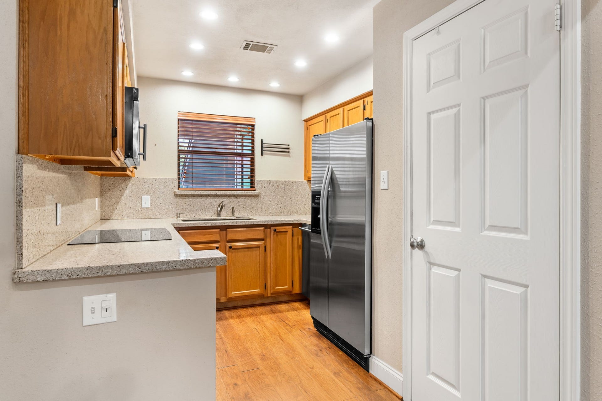 204 Lakeview Terrace, #G, Conroe, TX 77356 Granite counter tops and backsplash kitchen open to the living and dining area