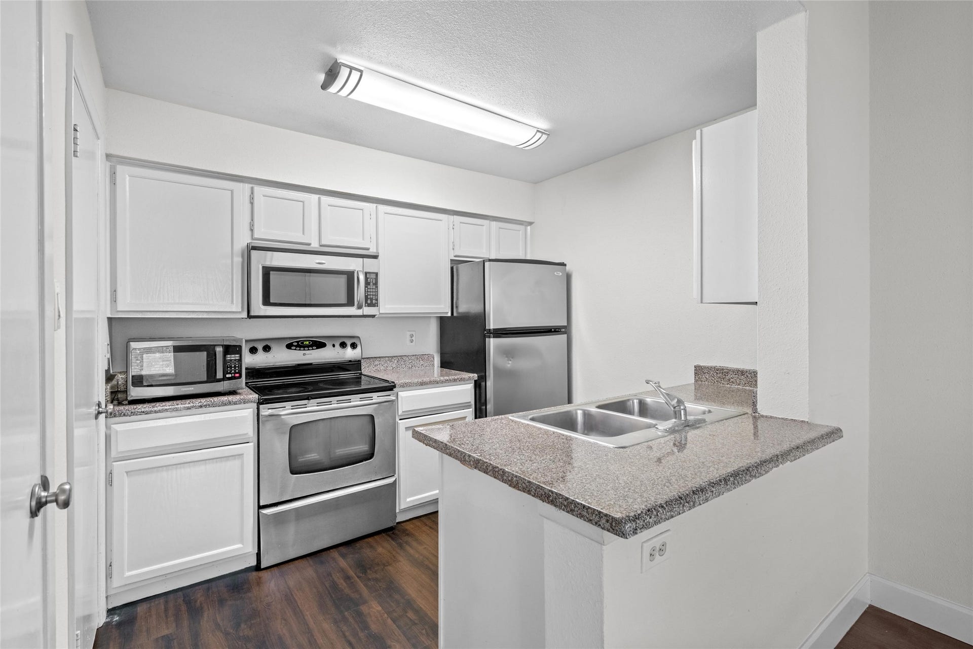 3900 Woodchase Drive, #162, Houston, TX 77042 Functional kitchen features white cabinetry, stainless-steel appliances, and generous counter space for everyday meal preparation.