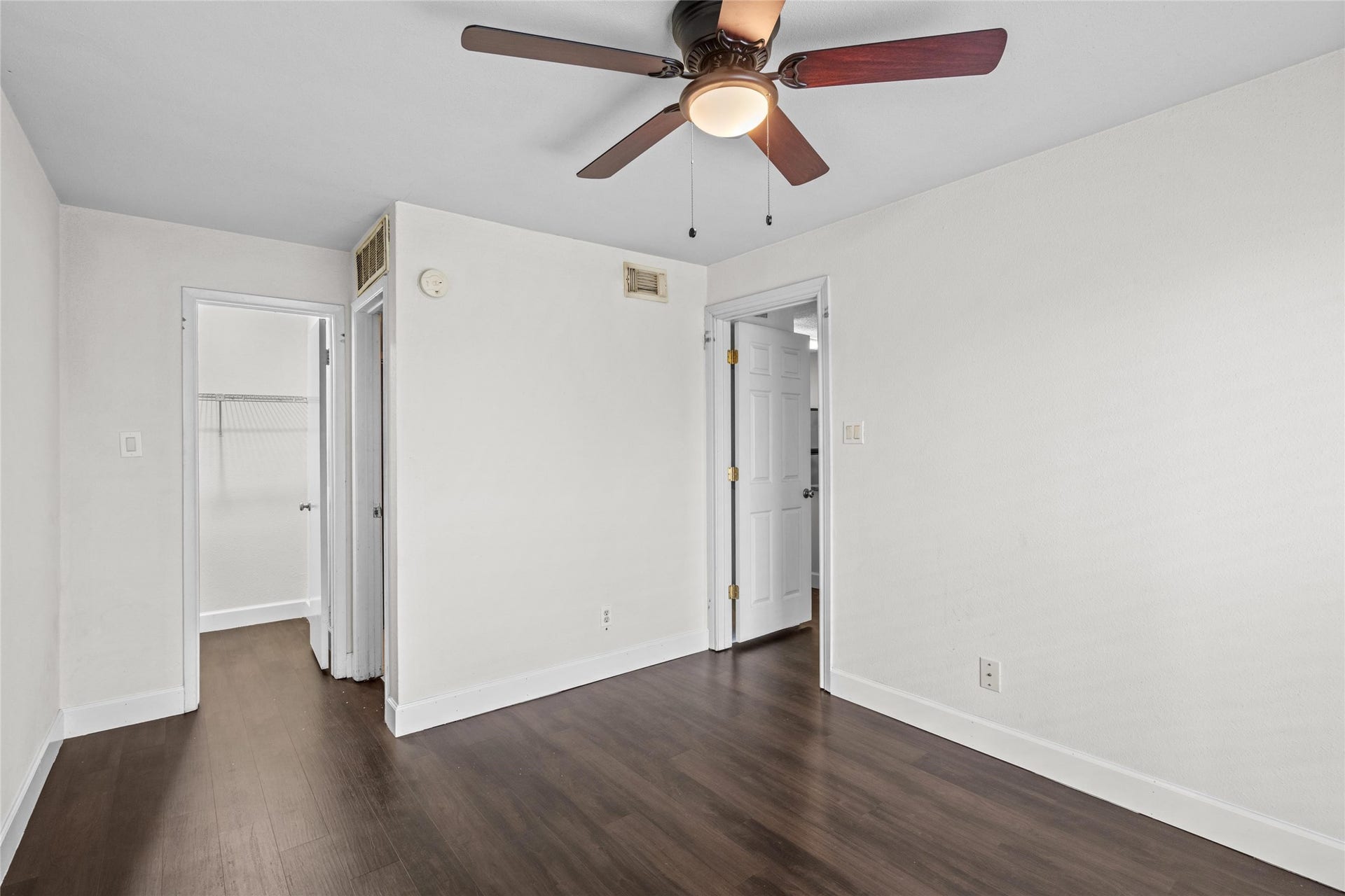3900 Woodchase Drive, #162, Houston, TX 77042 Well-sized bedroom features wood-look flooring, a ceiling fan, and natural light from the window