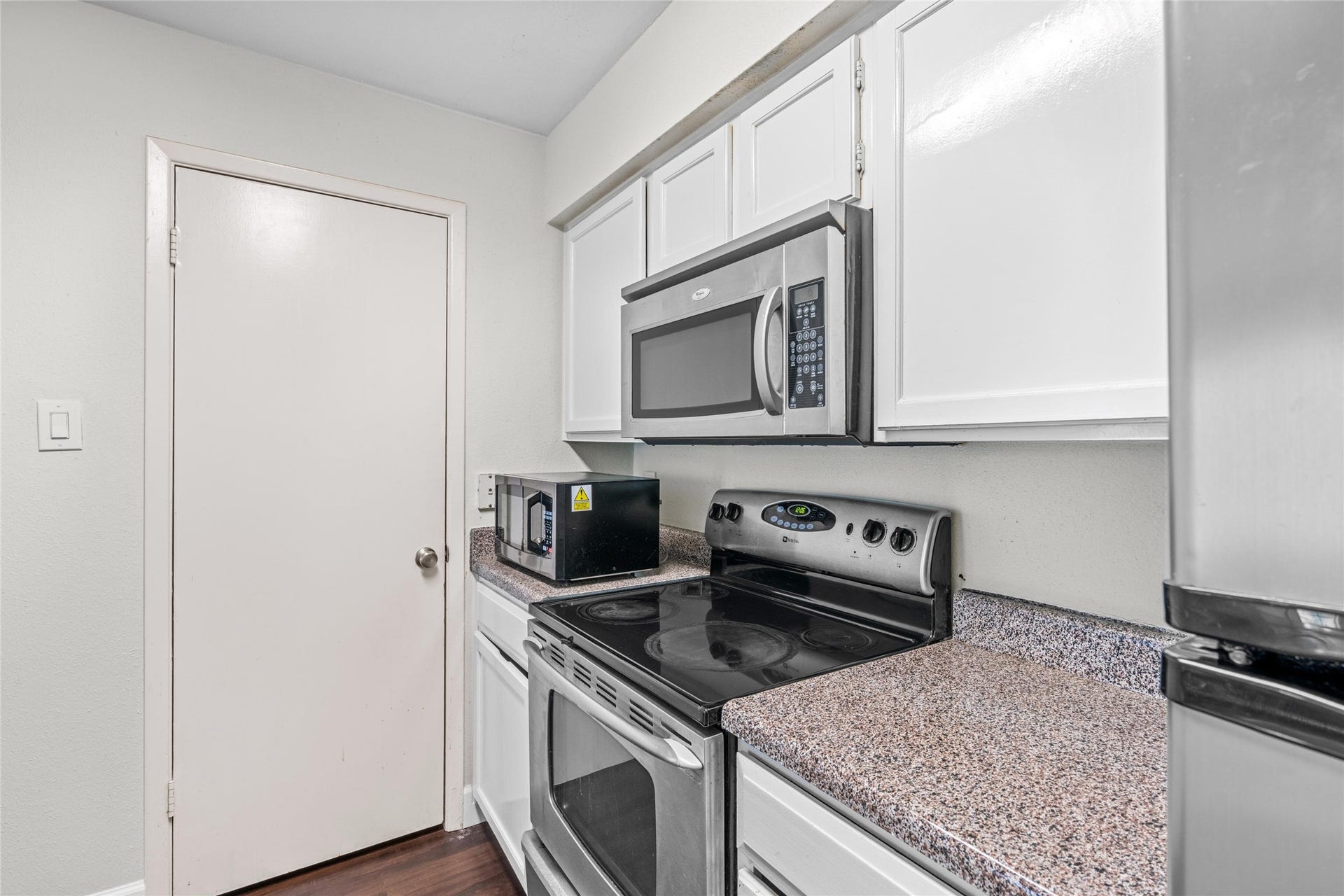 3900 Woodchase Drive, #162, Houston, TX 77042 Kitchen layout provides practical workspace with ample cabinetry and countertop area.