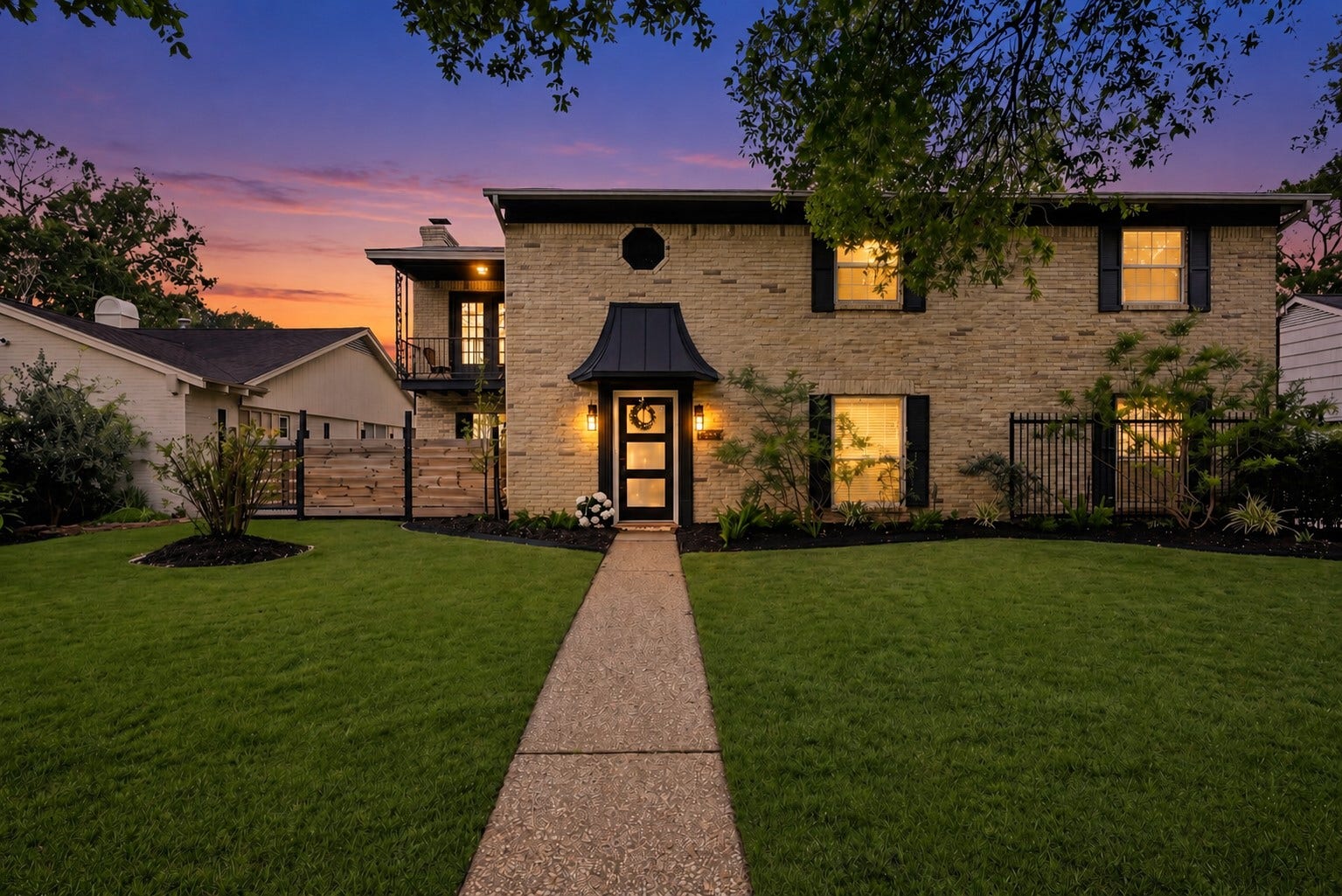 12574 Westerley Lane, Houston, TX 77077 Welcome home! Brickwork, a distinctive covered entry, and an upper balcony give the home memorable architectural character, beautifully framed by landscaping at dusk.