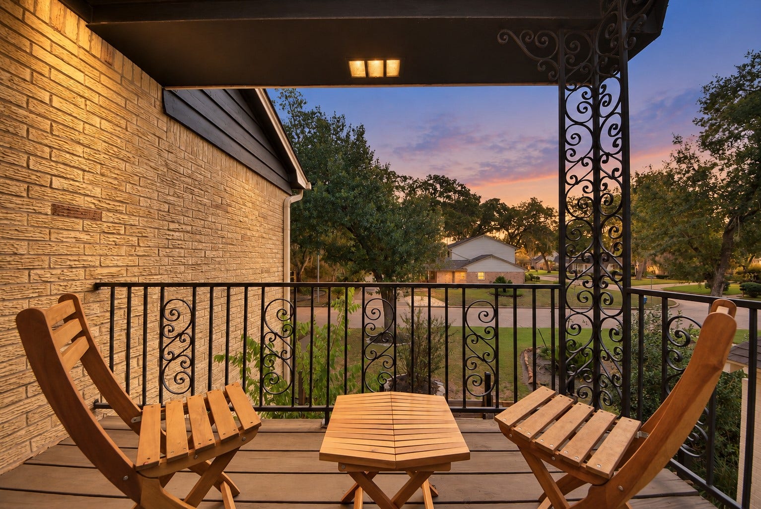 12574 Westerley Lane, Houston, TX 77077 Warmth at dawn:An upper-level covered balcony offers an inviting outdoor perch, with decorative ironwork, a leafy outlook, and the warm glow of evening. Perfect spot for morning coffee or evening tea.