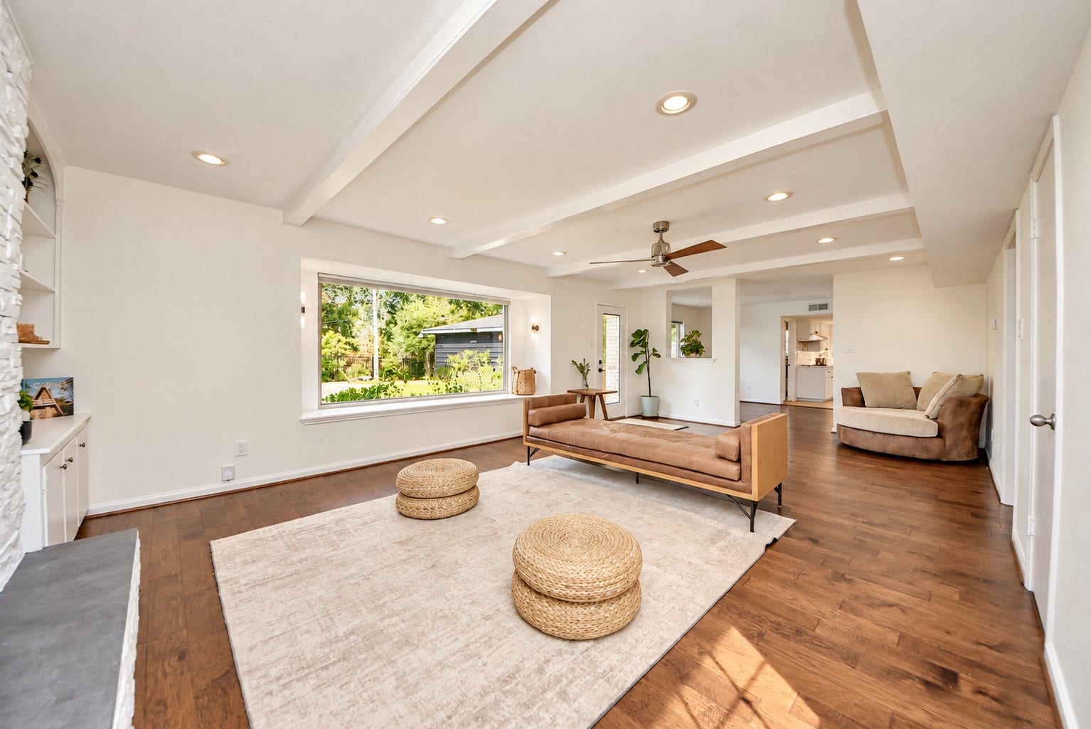 12574 Westerley Lane, Houston, TX 77077 Airy warm modern: Sunlight, striking beamed ceiling, warm wood flooring, create an airy living space with an easy flow into adjoining rooms.