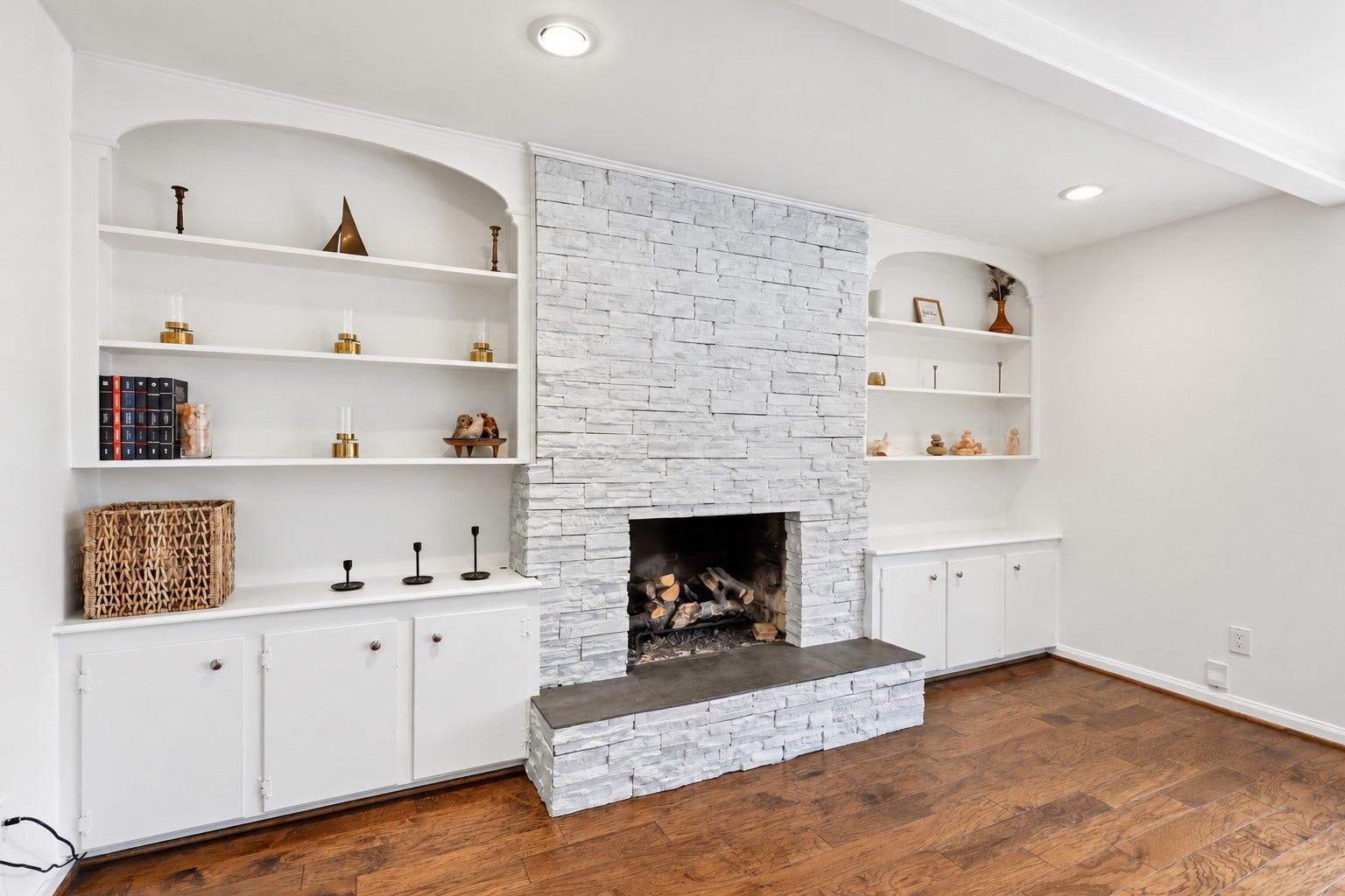 12574 Westerley Lane, Houston, TX 77077 Polished interior in natural daylight.png
Arched display shelves and lower cabinets frame the painted brick fireplace, creating a beautiful blend of architectural character and practical storage.