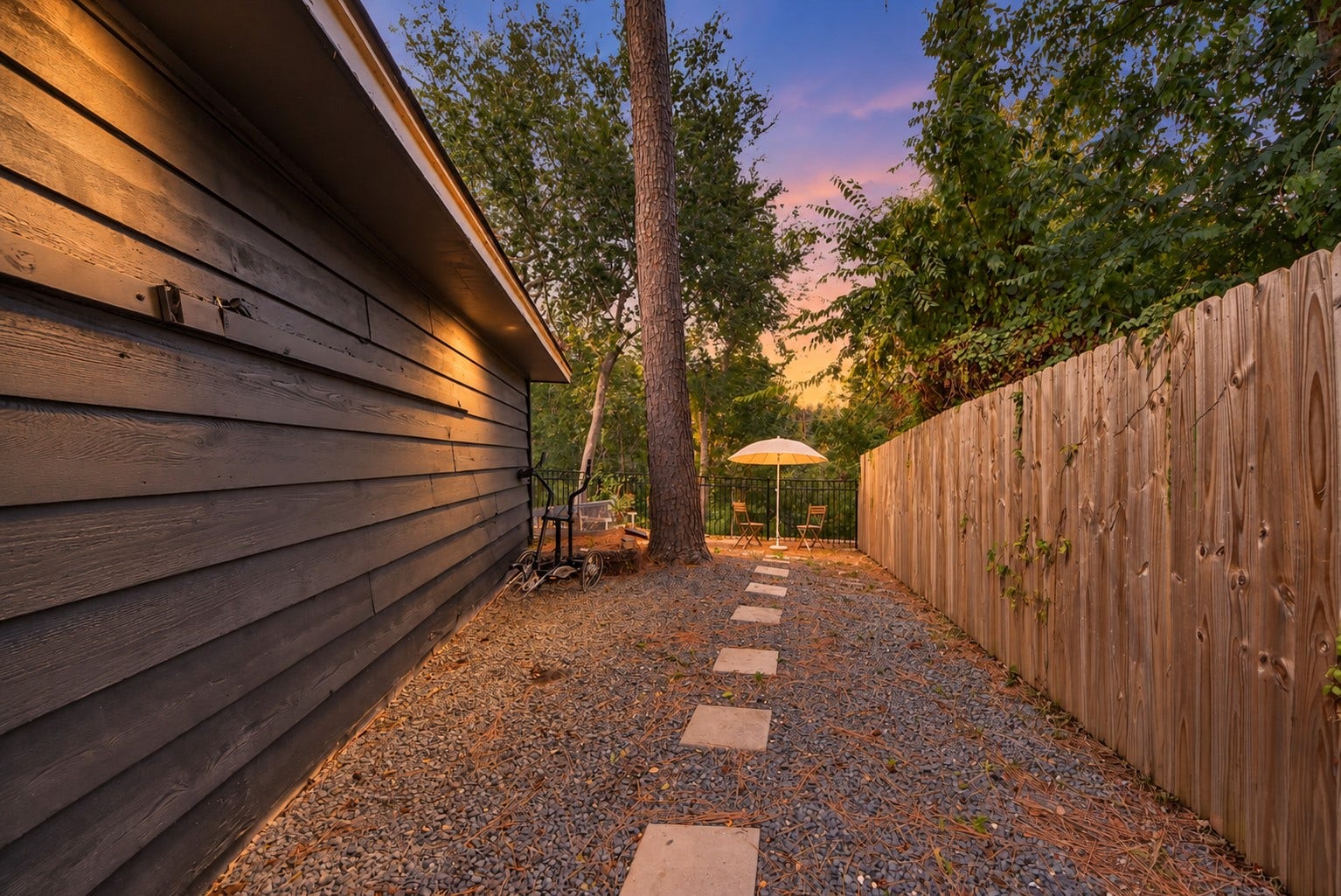 12574 Westerley Lane, Houston, TX 77077 A stepping-stone path runs beside the home through a tree-lined side yard, bringing texture and natural character to this outdoor path.