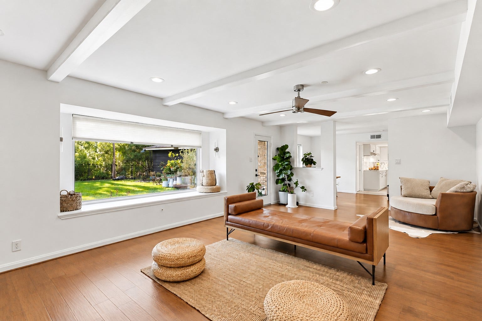 12574 Westerley Lane, Houston, TX 77077 Airy warm modern: Sunlight, striking beamed ceiling, warm wood flooring, create an airy living space with an easy flow into adjoining rooms.