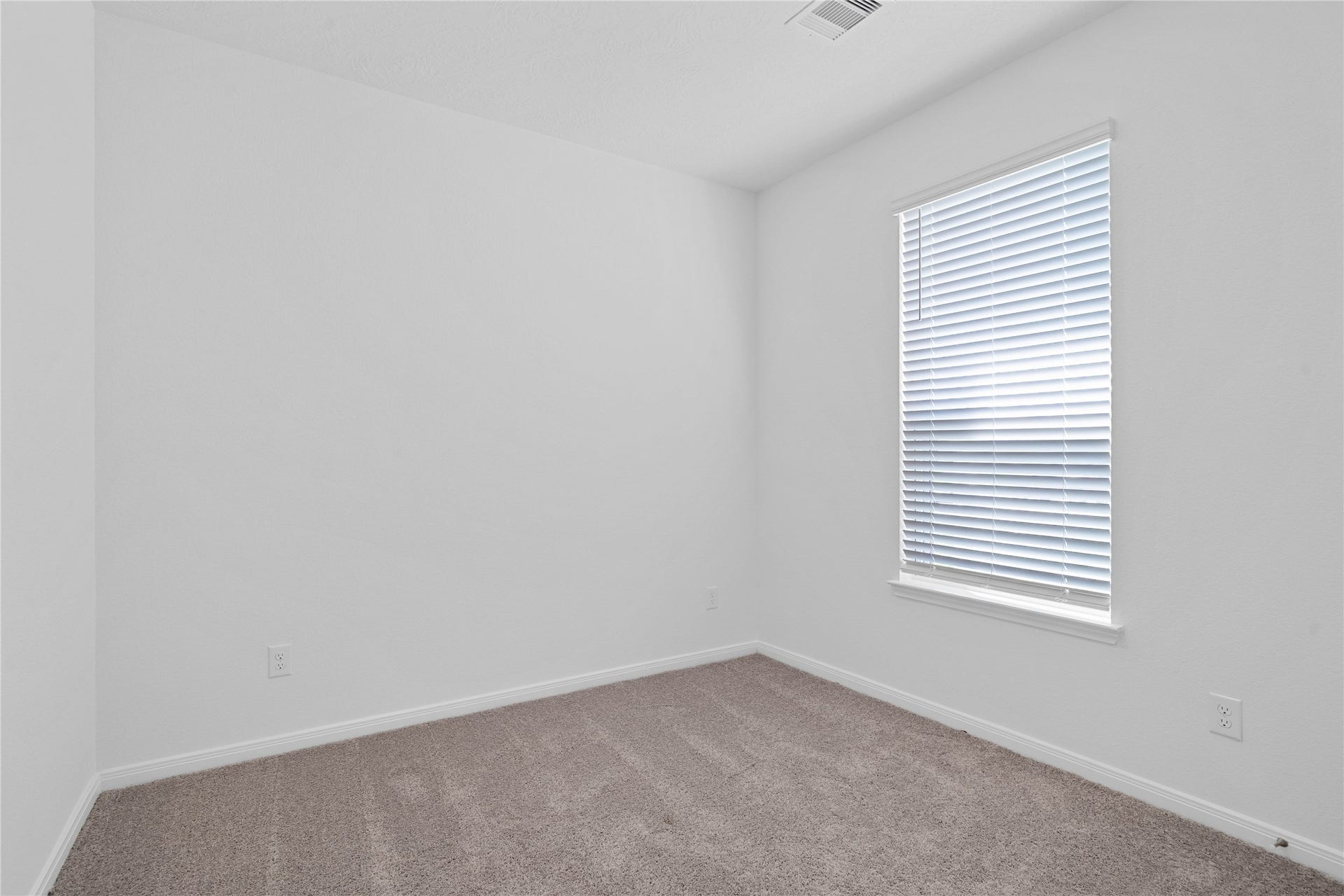 5619 Blackbird Lane, Hitchcock, TX 77563 Tucked peacefully in the front of this home is this secondary bedroom. It offers comfort and style with plush carpeting, neutral paint tones, recessed lighting, a large window with blinds, and a generously sized closet.
