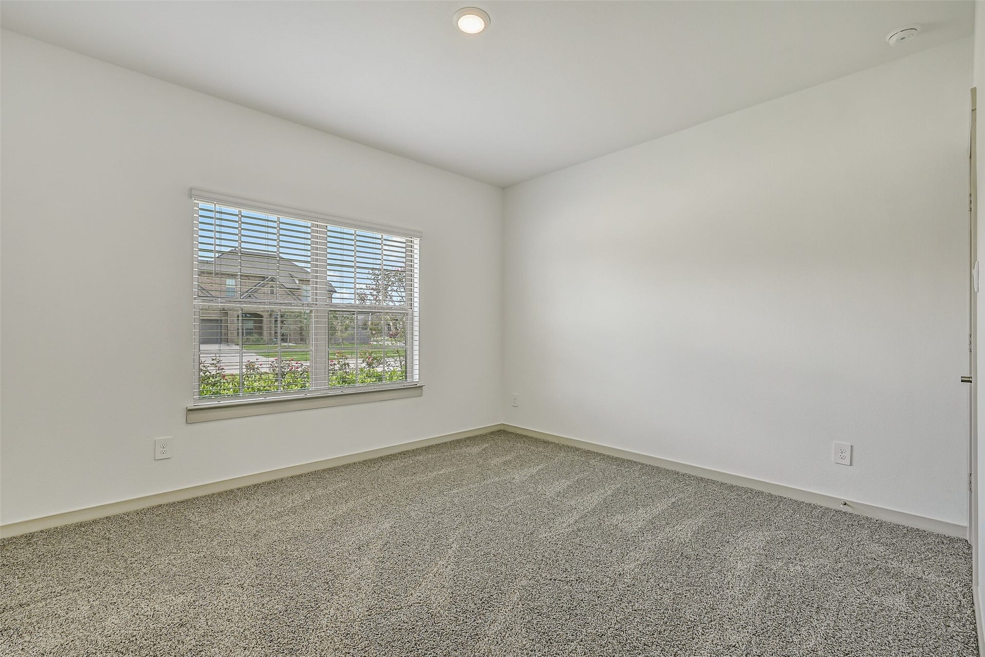 6204 Red Oak Court, League City, TX 77573 Another secondary bedroom offers plush neutral carpet, a large front-facing window and a versatile blank canvas ready to accommodate a variety of furnishings and uses.