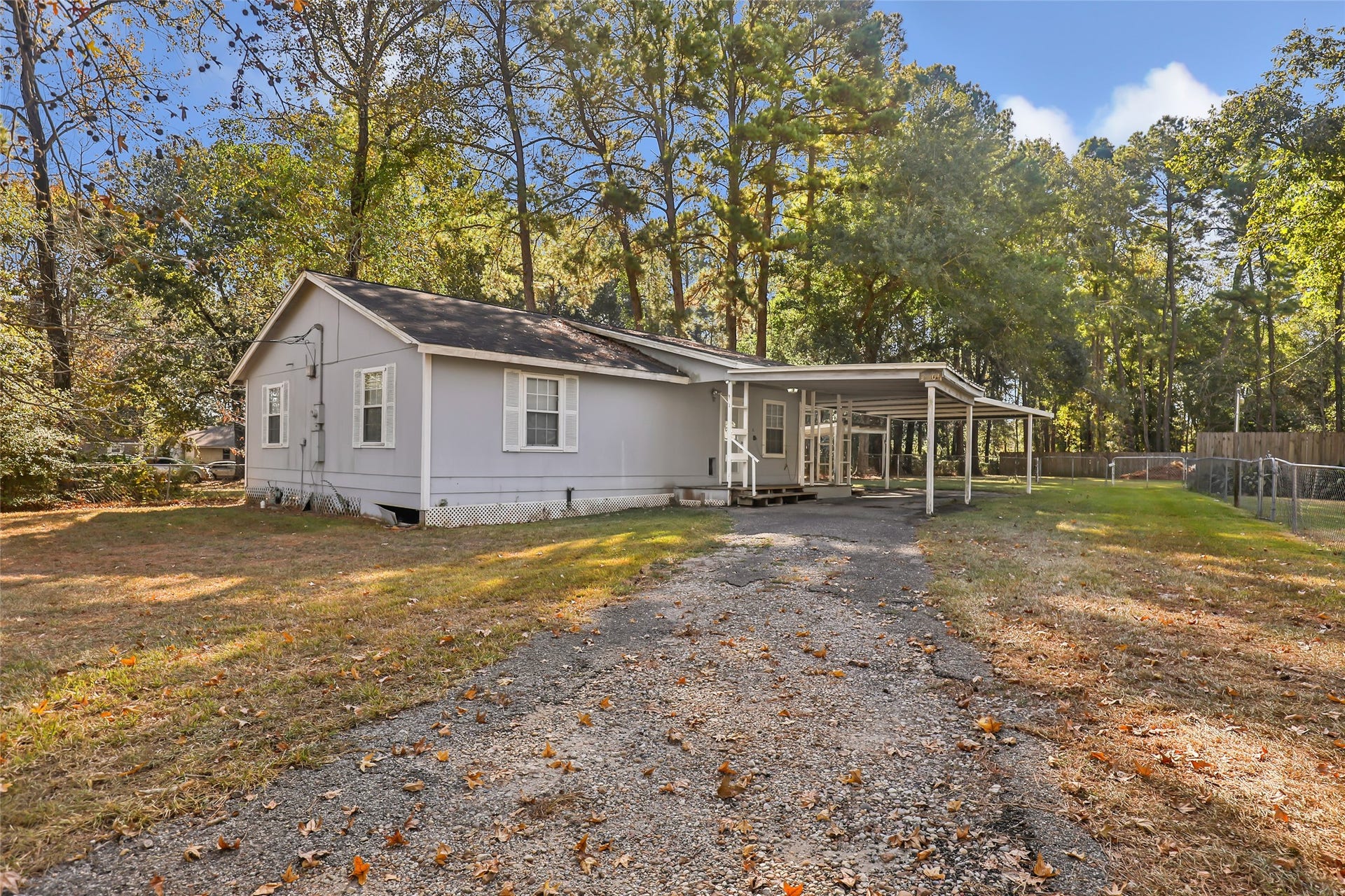 23304 E Community Drive, New Caney, TX 77357 Spacious lot, asphalt driveway and covered parking, conveniently located in New Caney near US-59 and the Grand Parkway.