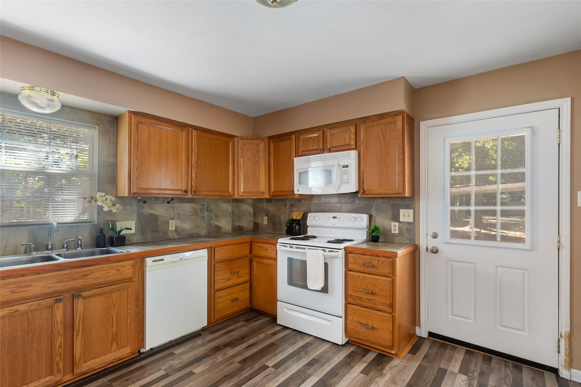 23304 E Community Drive, New Caney, TX 77357 Plenty of cabinet storage, with a range, microwave and dishwasher included.