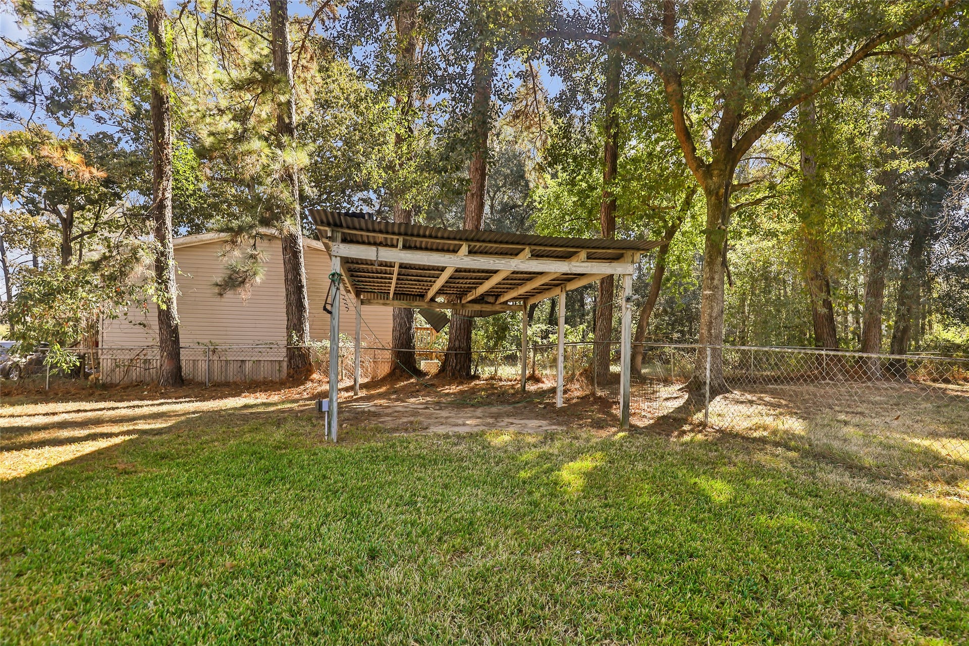 23304 E Community Drive, New Caney, TX 77357 Additional carport can be used for car, boat or mower storage.