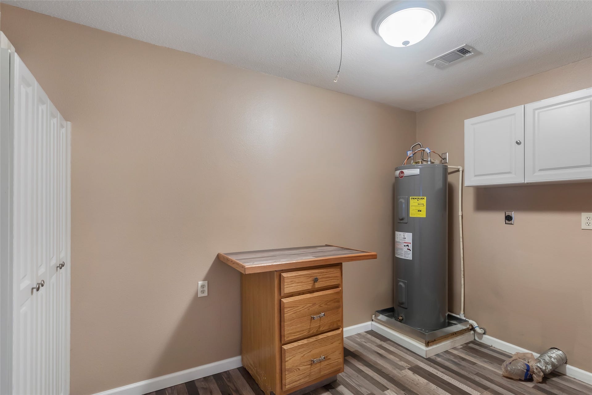 23304 E Community Drive, New Caney, TX 77357 Dedicated utility space with water heater and additional storage potential.