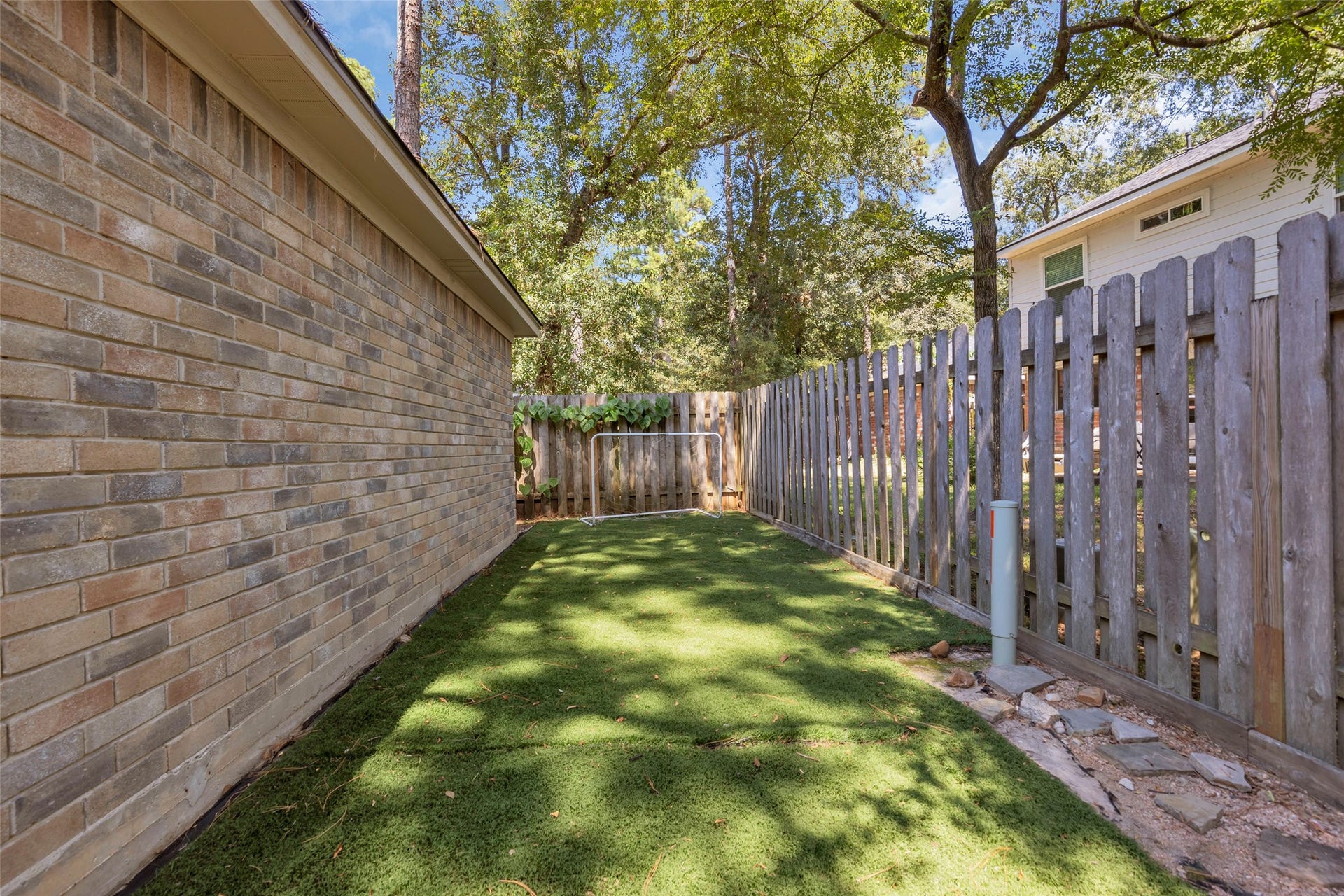 2 Tall Sky Place, The Woodlands, TX 77381 Turf was added behind the detached garage