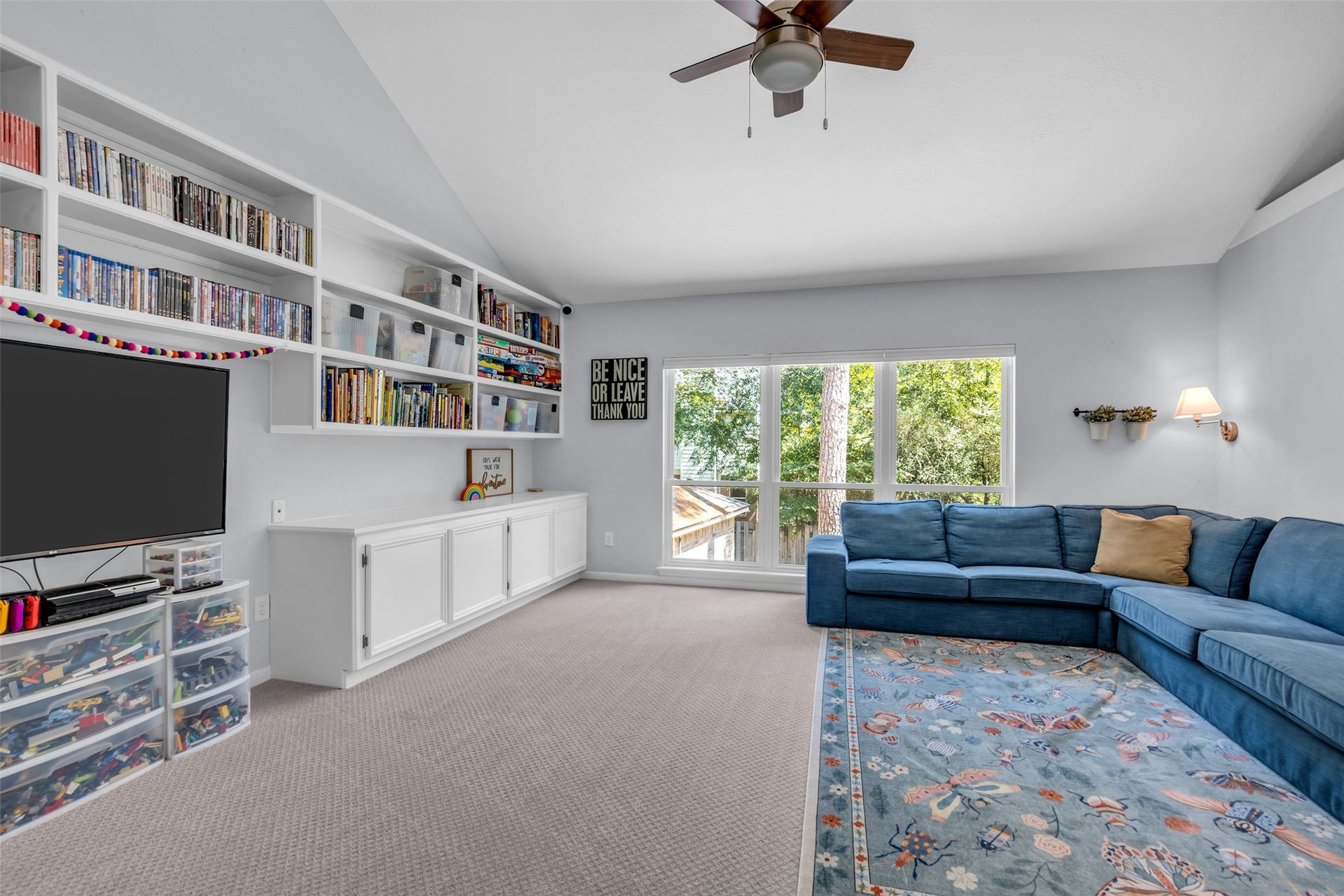2 Tall Sky Place, The Woodlands, TX 77381 Upstairs game room with custom bookshelves