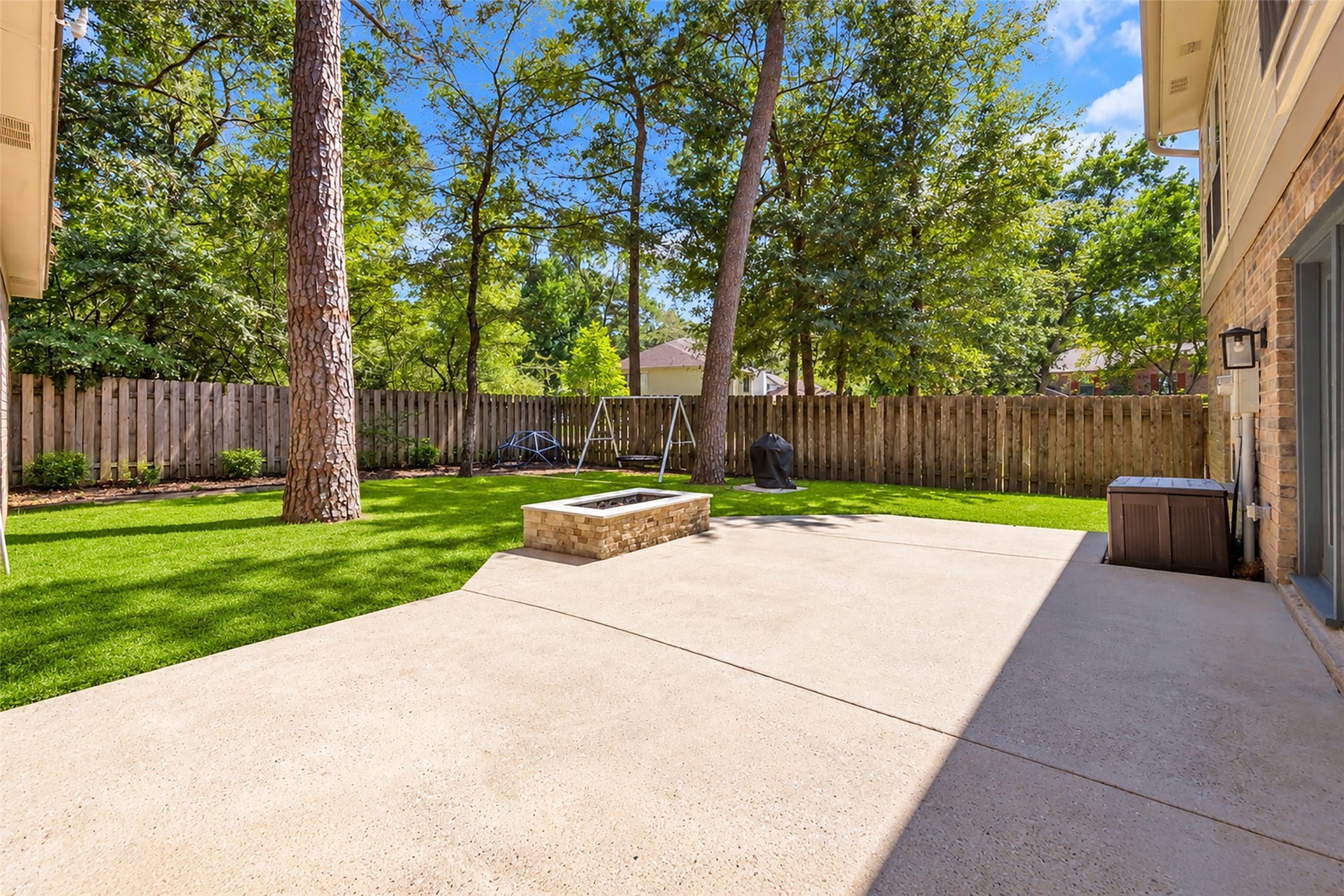2 Tall Sky Place, The Woodlands, TX 77381 Large backyard with shade, firepit, and stone path walkway