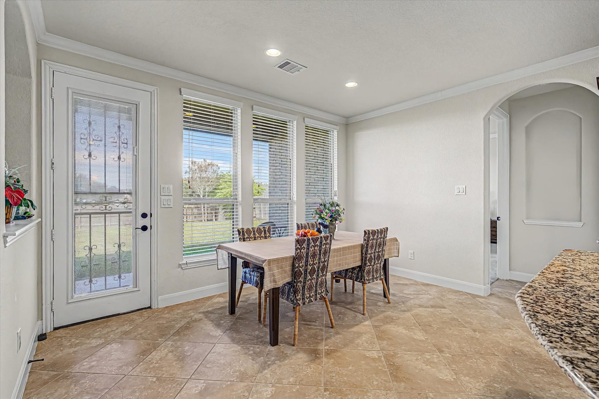 20302 Bandera Lake Lane, Richmond, TX 77407 Bright and inviting breakfast area with large windows, offering abundant natural light and a charming view of the backyard.