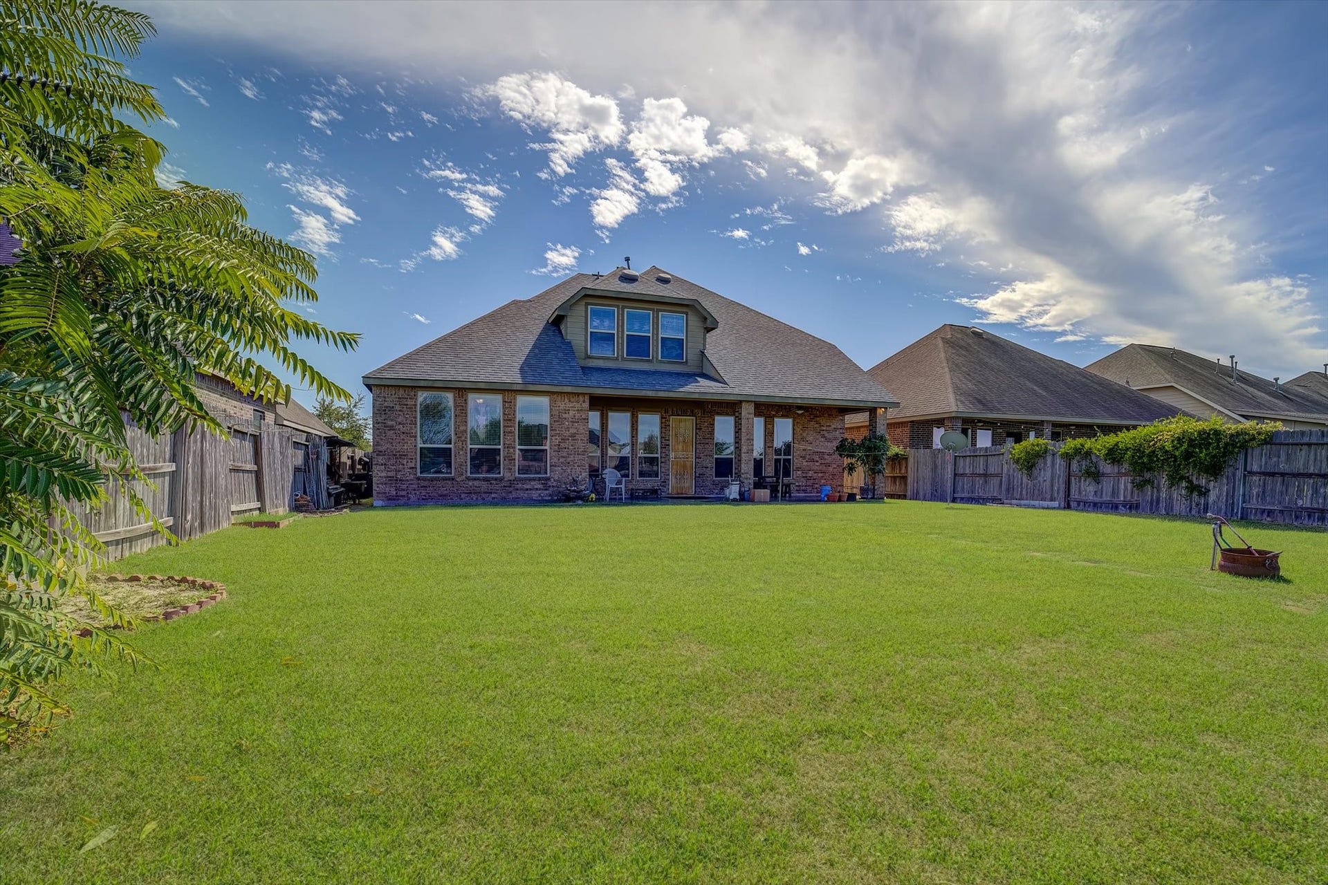 20302 Bandera Lake Lane, Richmond, TX 77407 Expansive backyard with lush green lawn perfect for outdoor activities and entertaining.