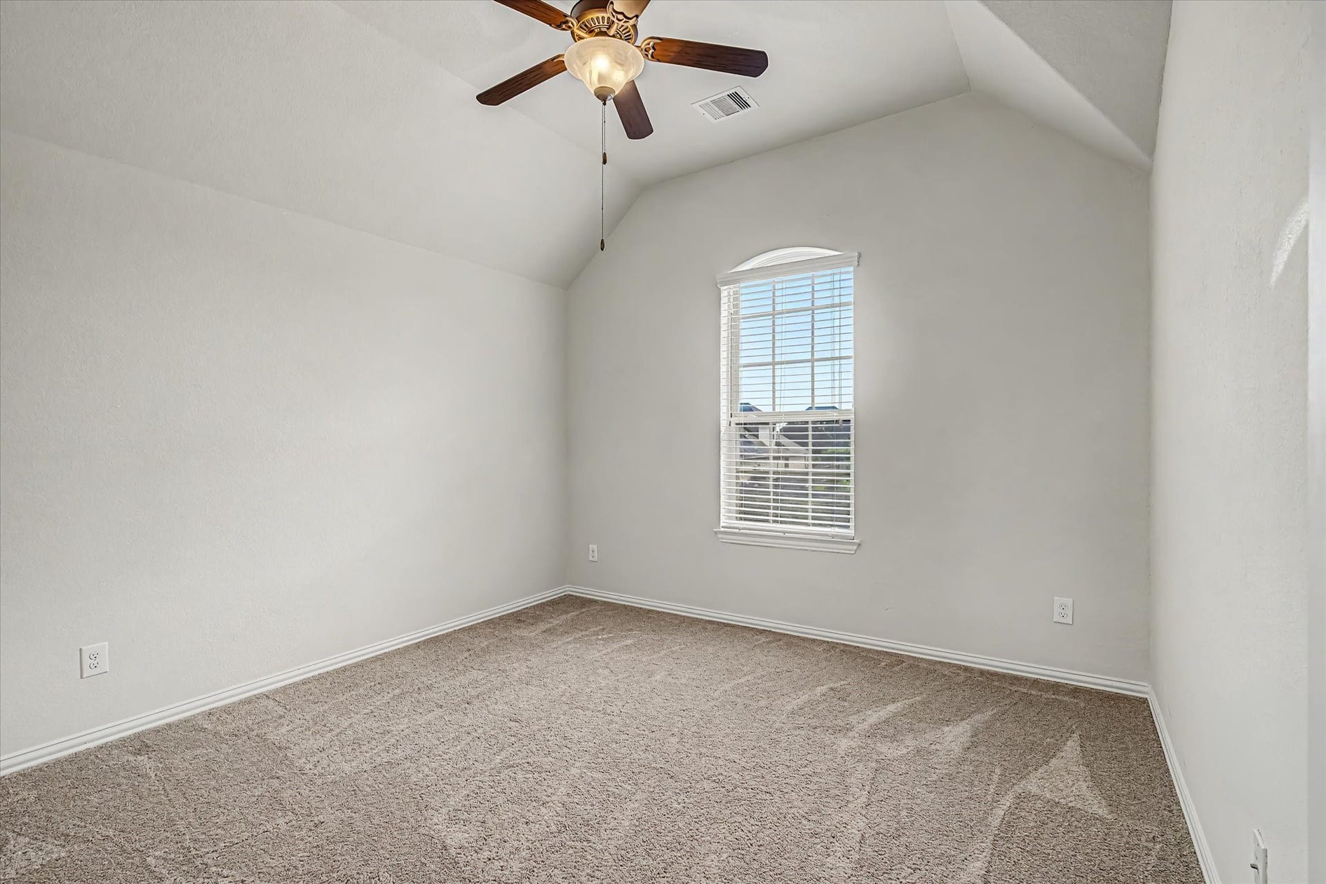 20302 Bandera Lake Lane, Richmond, TX 77407 Bright and inviting room with plush carpet, vaulted ceiling, and a stylish ceiling fan, perfect for a cozy bedroom.