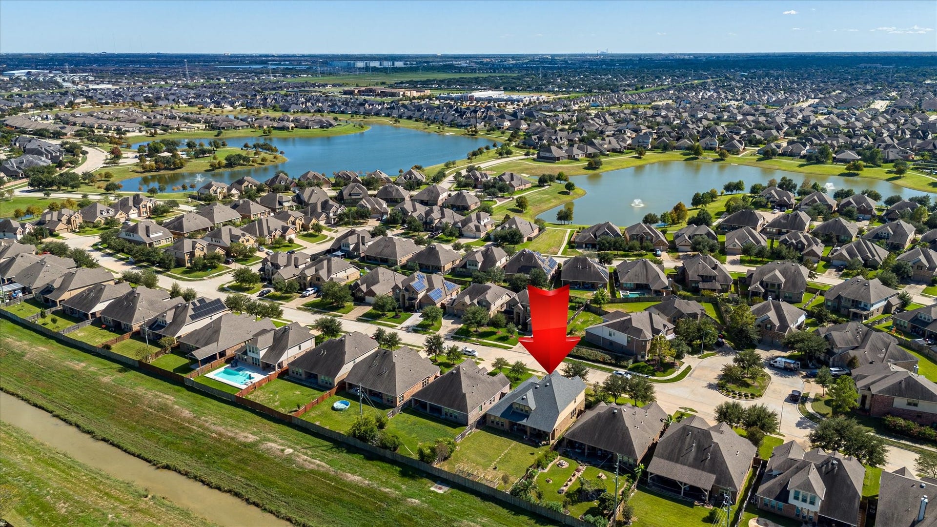 20302 Bandera Lake Lane, Richmond, TX 77407 Charming home nestled in a picturesque neighborhood, highlighted by scenic lakes and lush greenery, offering a tranquil suburban lifestyle.