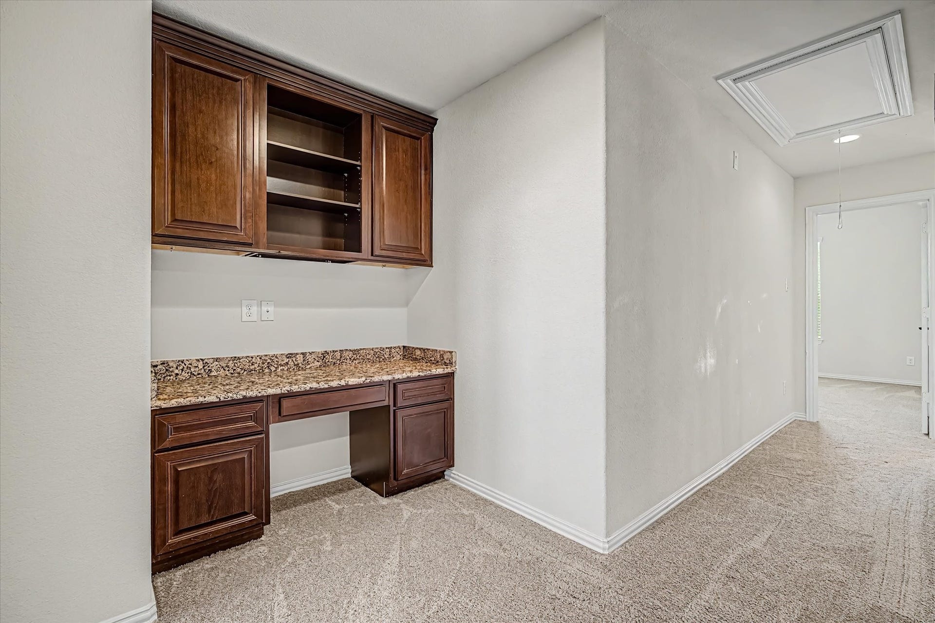 20302 Bandera Lake Lane, Richmond, TX 77407 Charming home office nook with rich wooden cabinetry and a granite countertop, perfect for productivity and organization.