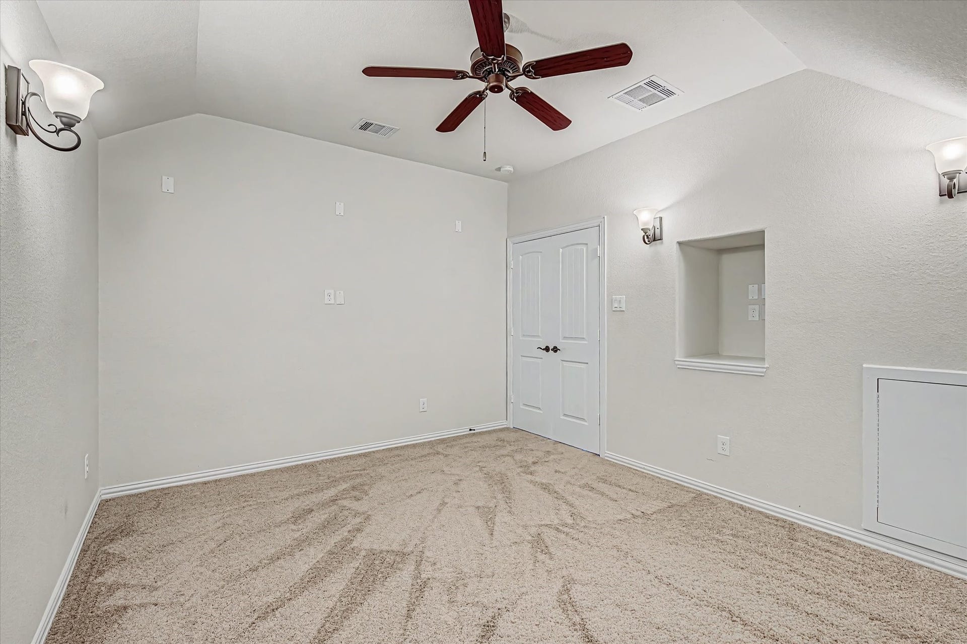 20302 Bandera Lake Lane, Richmond, TX 77407 Media room with soft carpet flooring, elegant wall sconces, and a ceiling fan.