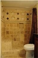 6001 Reims Road, #1202, Houston, TX 77036 This bathroom features warm-toned, tiled walls with decorative accents, a shower curtain, and a white toilet. It offers a cozy, classic feel.
