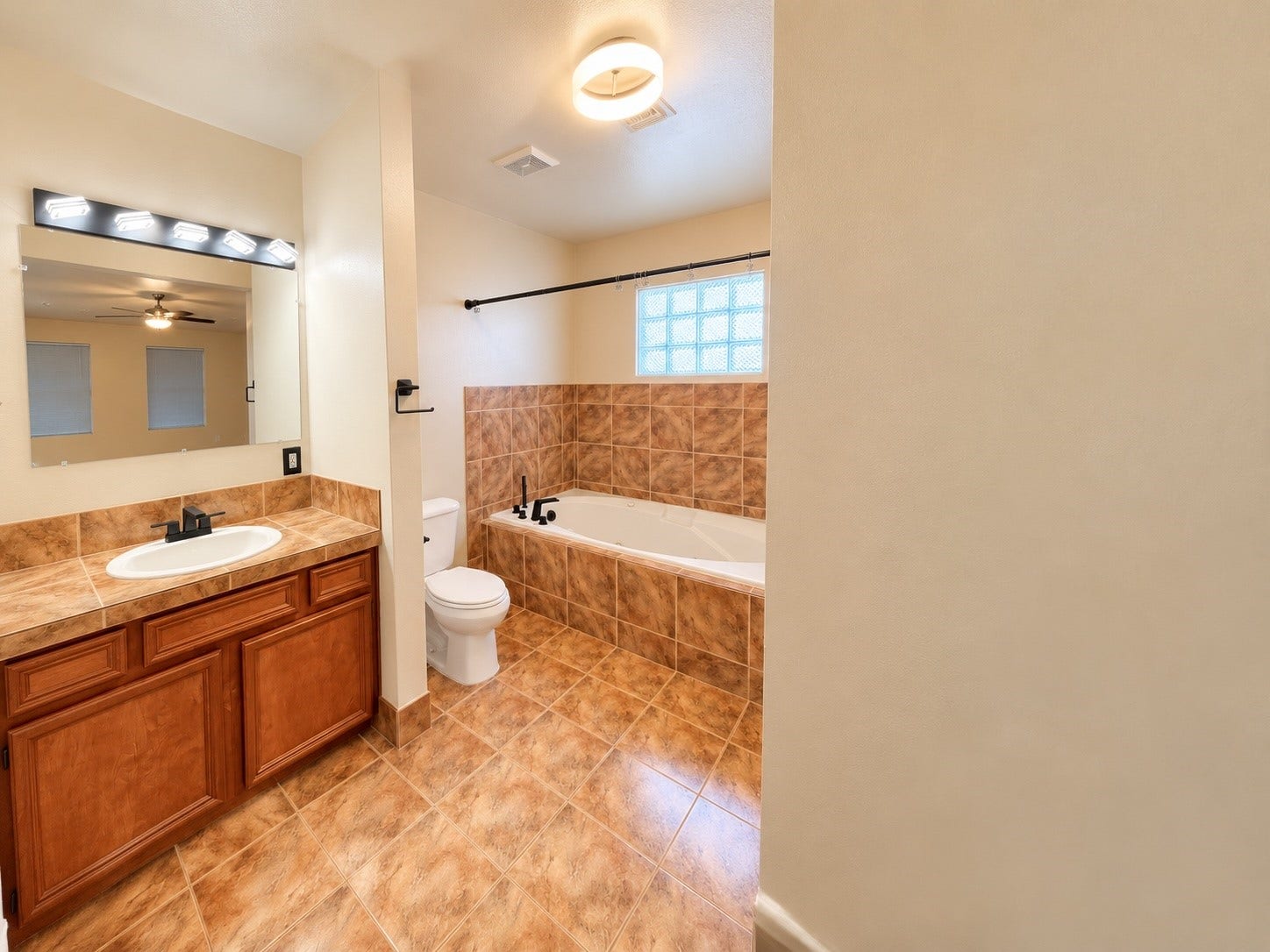 Primary bathroom with jacuzzi tub to relax.