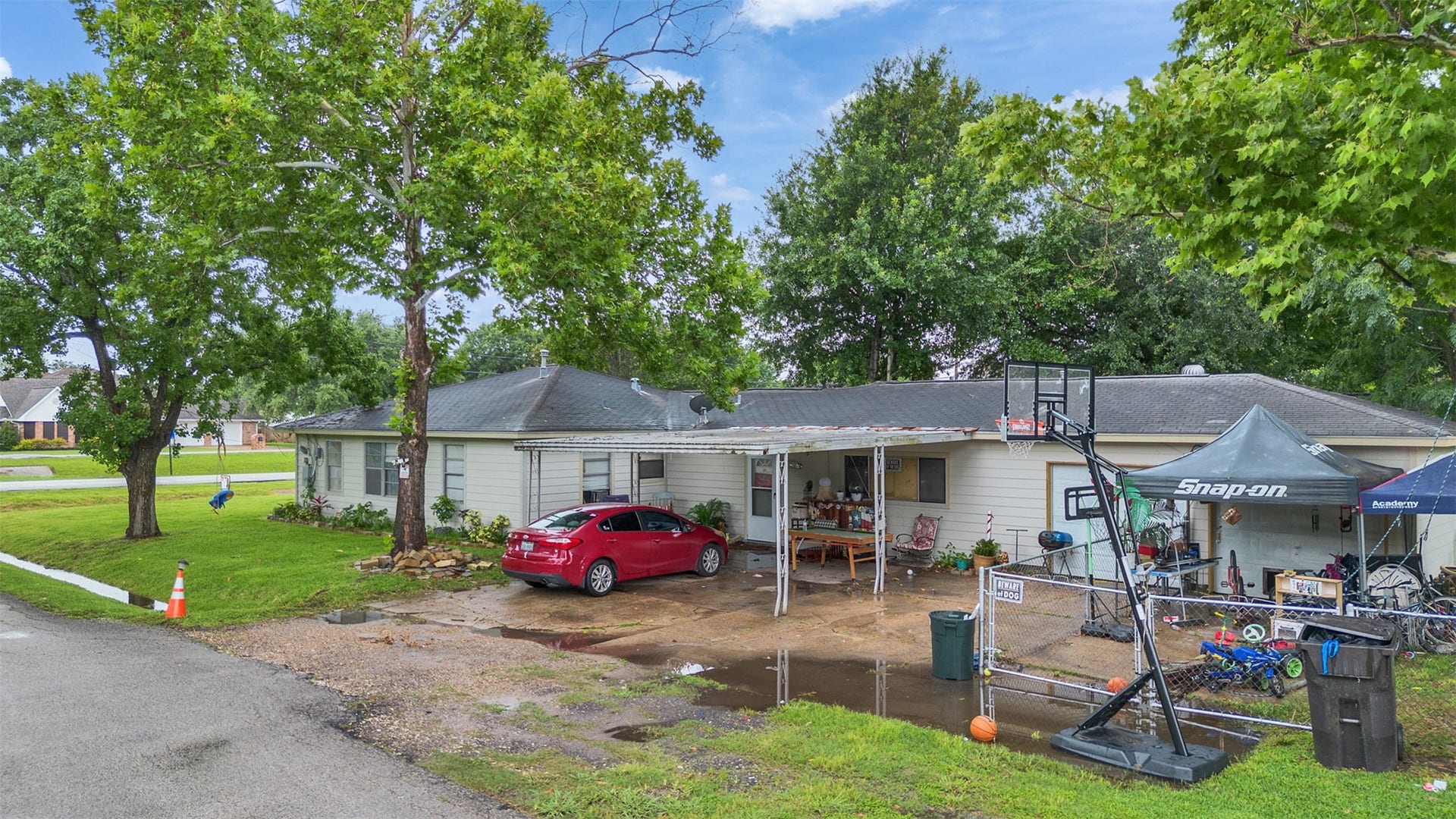 815 Avenue G, South Houston, TX 77587 This space showcases the convenient carport area along with a secondary entrance into the home. Designed with functionality in mind, this area offers easy access, extra storage, and plenty of room for parking and projects.