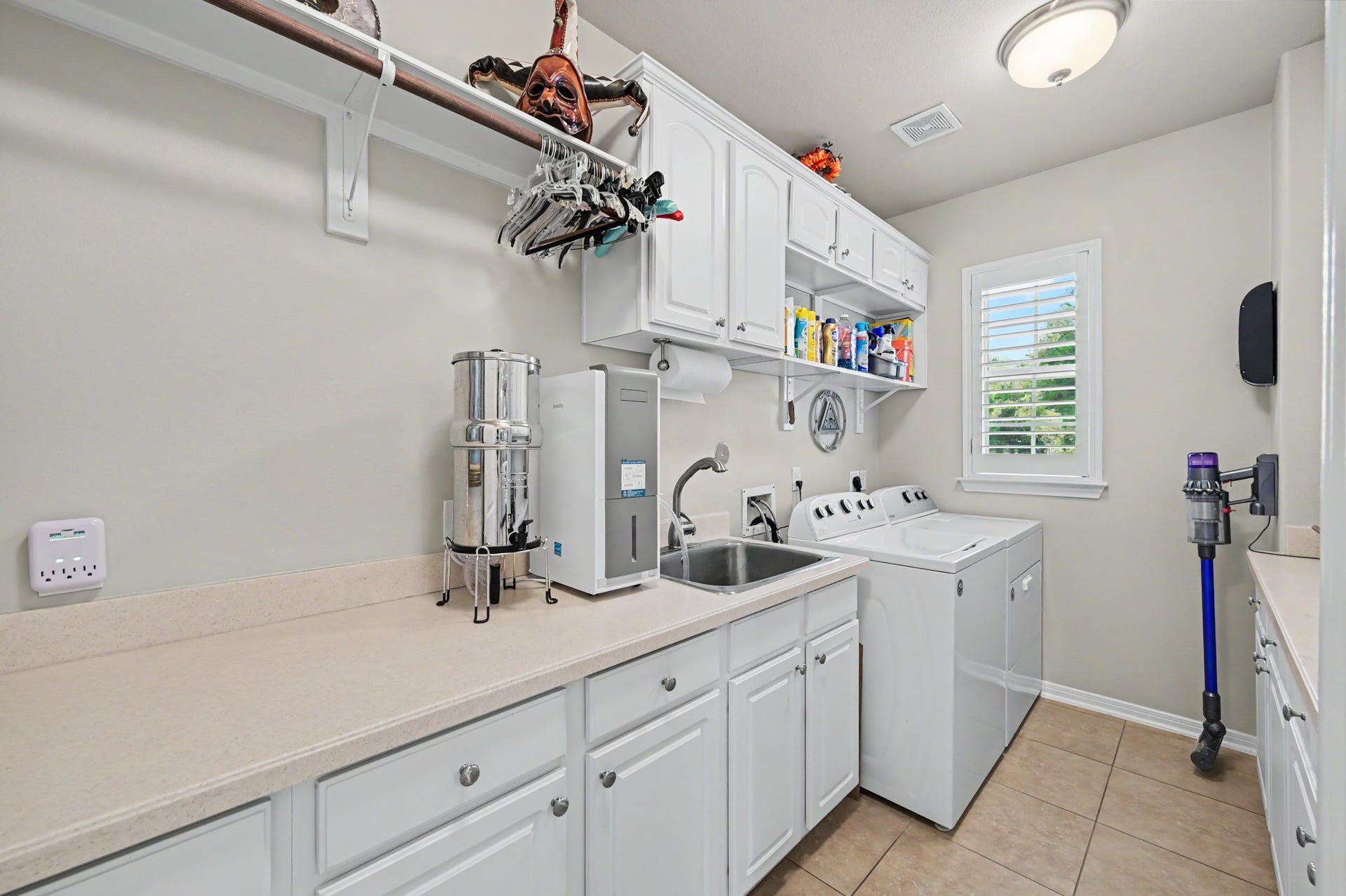 124 Wycliffe Drive, Montgomery, TX 77356 Spacious utility room with sink, extensive cabinetry, and convenient workspace.