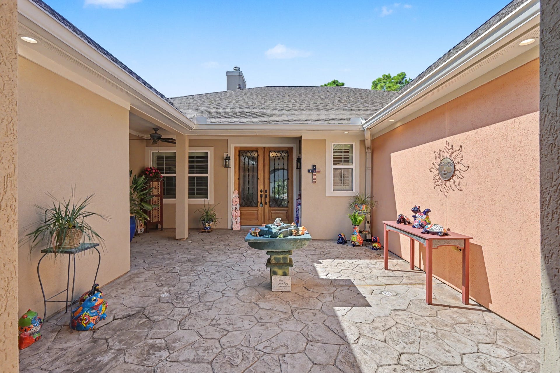 124 Wycliffe Drive, Montgomery, TX 77356 Charming private courtyard with attractive stonework and inviting outdoor space.