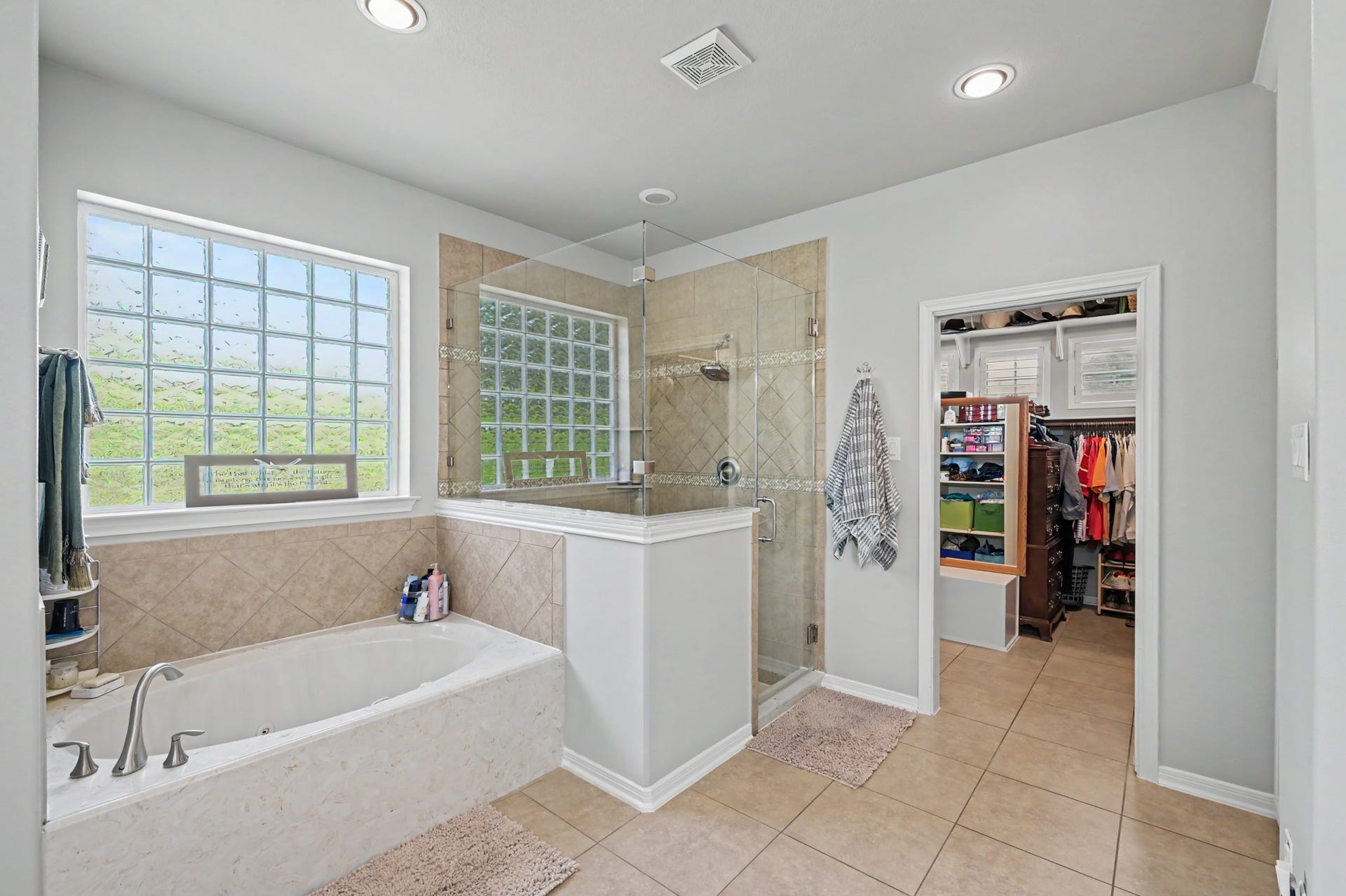 124 Wycliffe Drive, Montgomery, TX 77356 Relaxing primary bath featuring a jetted soaking tub, separate shower, and natural light.